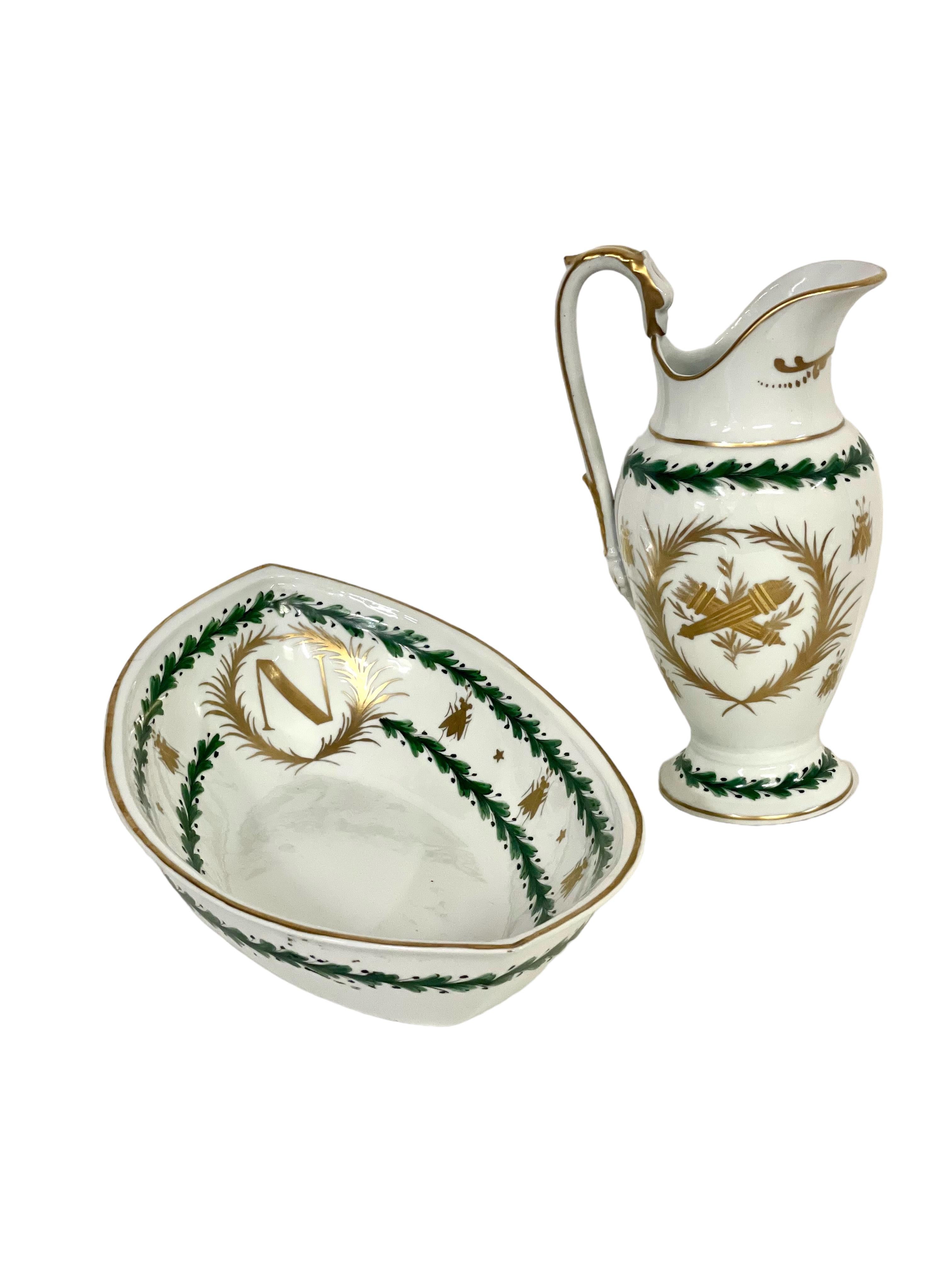 An extremely elegant Paris Porcelain wash basin and pitcher dating from the First Empire Period, around 1815, and featuring as its decoration the emblems of the Emperor Napoleon himself: an eagle, bees, laurel wreaths and the capital letter 'N'. The