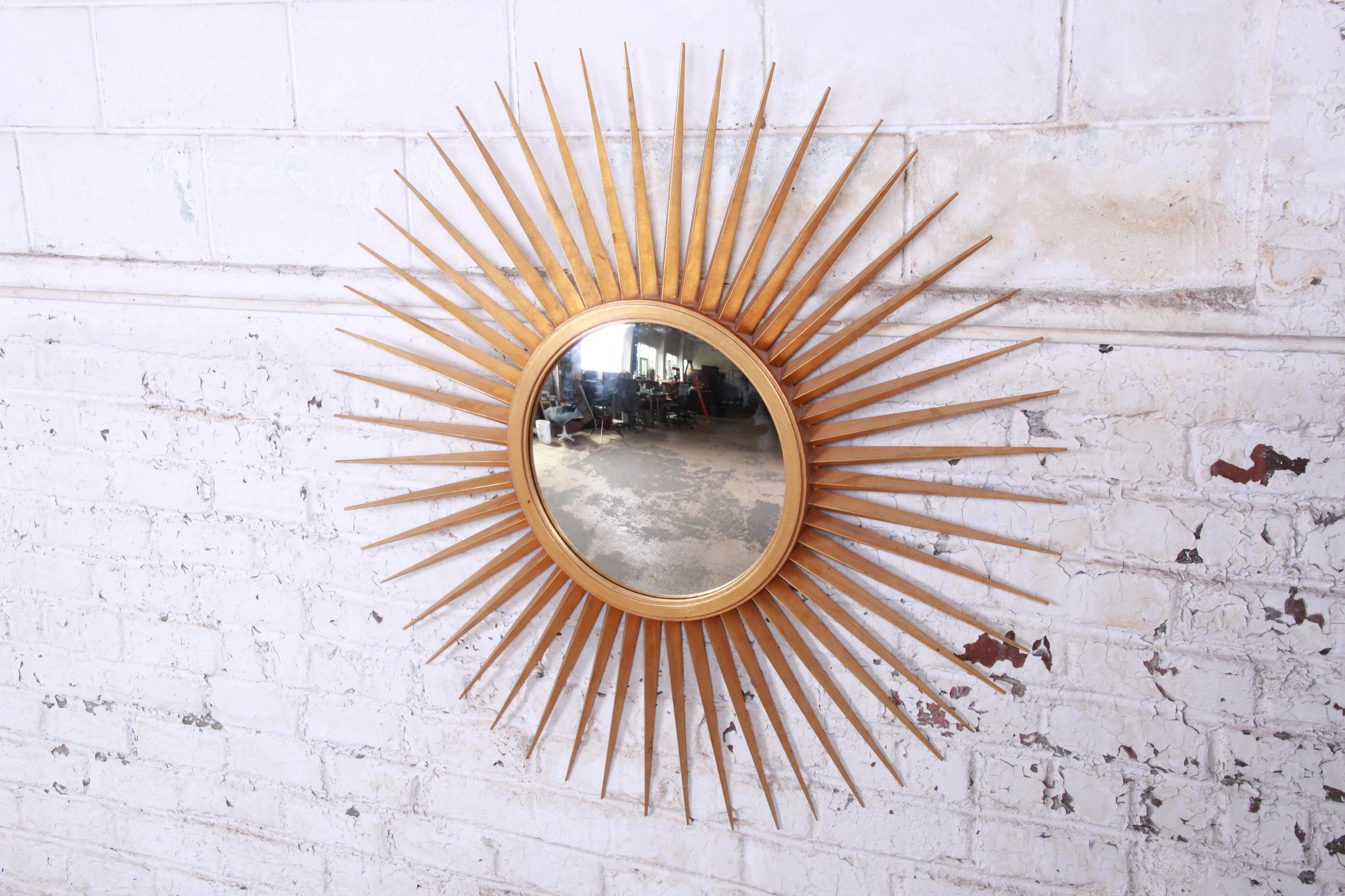 An exceptional gilded wood sunburst convex wall mirror by the iconic design team of Parish-Hadley for Baker Furniture. For interior design aficionados, Parish-Hadley Associates is an institution. The firm had an indelible impact on American