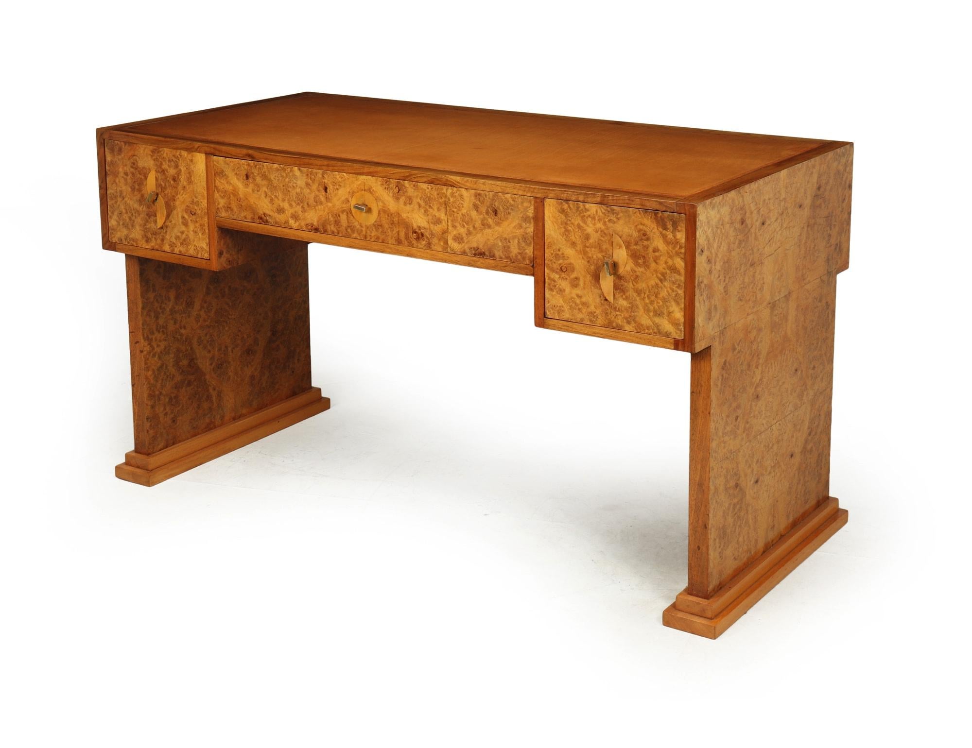 An exceptional quality Art Deco Desk produced in solid oak and walnut with burr maple veneers, thick Hyde Leather writing surface with greek key tooling, decorative inlaid escutcheons and long quality locks with keys.

The desk has been fully