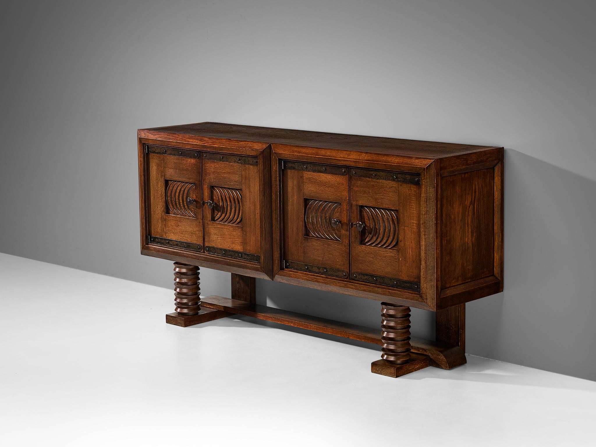 Georges & Gaston Guérin, sideboard, solid oak, iron, Paris, France, 1930s/40s

Made in Paris, this sideboard is designed according to the French Art Deco design principles that rose to prominence in the 1930s and 1940s. This credenza clearly shows