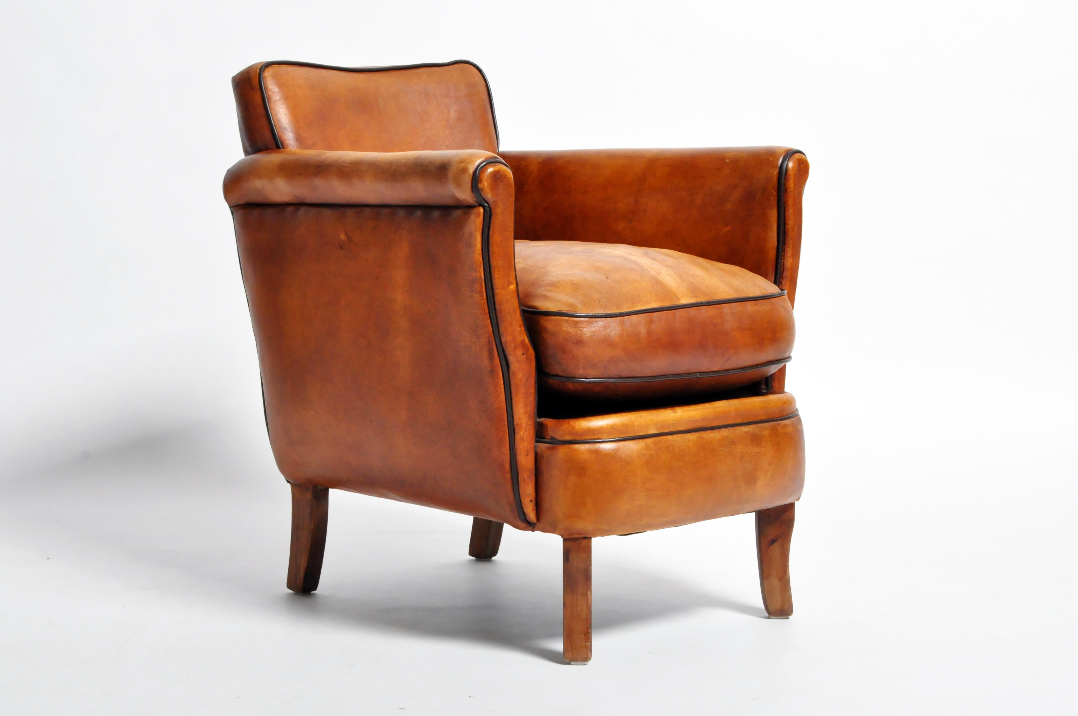 This newly made brown armchair is from France and made from leather and wood. Comfortable and sturdy, ready for daily use.