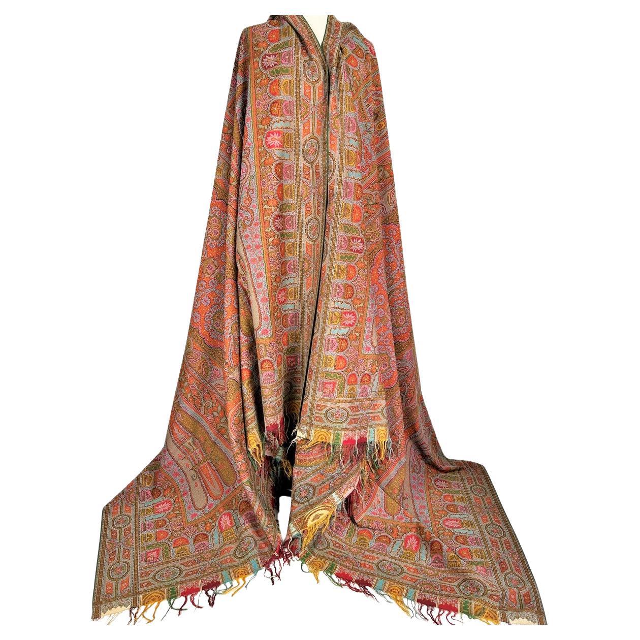 Circa 1855-1860
France Paris 
A French long Cashmere Paisley shawl, possibly from The Hébert House, with poly-lobed reserve and unidentified signature dating from the early Second French Empire. Very fine eight-colour cut-throw weaving on a Jacquard
