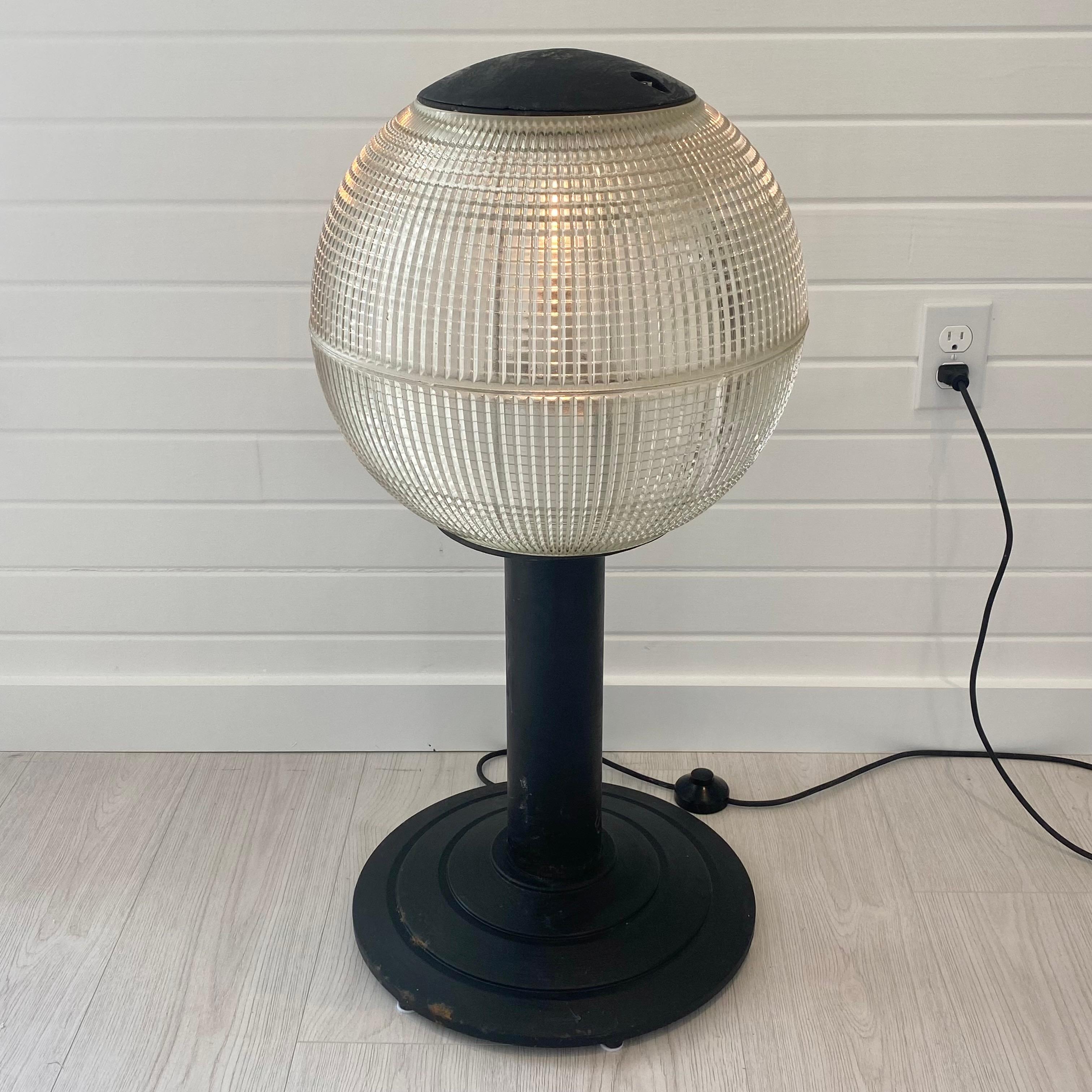 Unique original holophane globe street light from Paris which has been perfectly converted into a floor lamp. Black metal base sustains the globe. Glass illuminates beautifully through the art deco waffle glass. Fully rewired for the US with floor