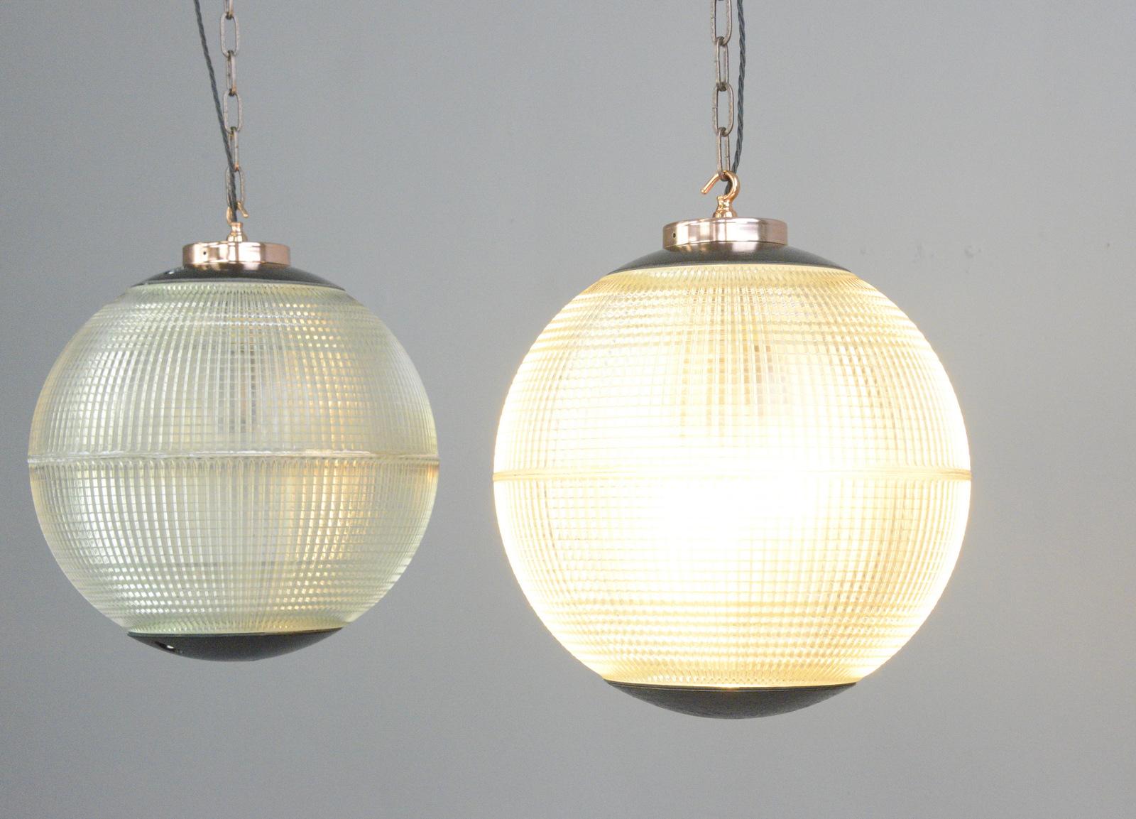 Parisian Holophane globe lights, circa 1950s

- Price is per light
- Heavy prismatic glass
- Comes with chain and ceiling hook
- Takes E27 fitting bulbs
- Polished copper top and hook
- Originally used on the tops of street lamps across