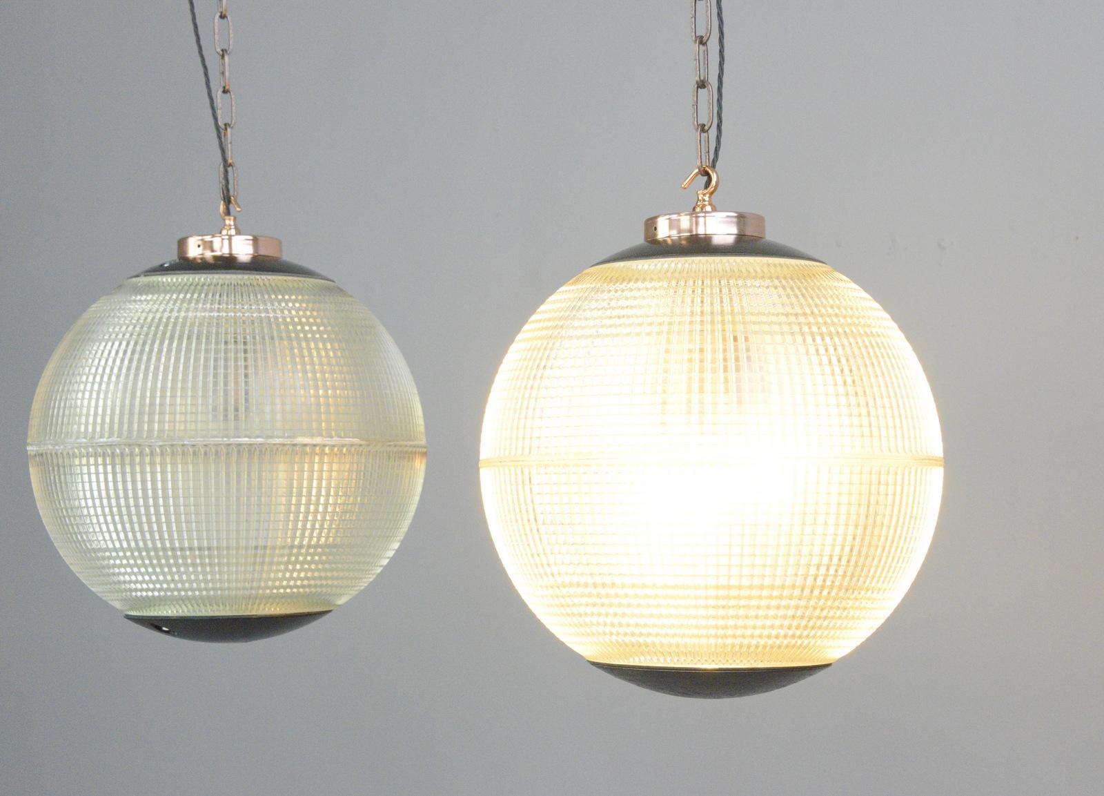 Parisian Holophane globe lights, circa 1950s

- Price is per light
- Heavy prismatic glass
- Comes with chain and ceiling hook
- Takes E27 fitting bulbs
- Polished copper top and hook
- Originally used on the tops of street lamps across Paris
- Made