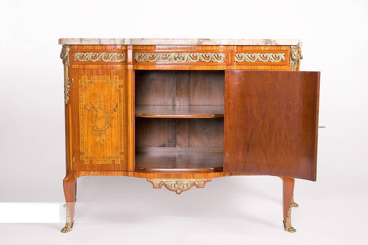 The Parisian commode was created in the historicism. It is modeled on the epoch of transition, from Rococo to Louis XVI. The basic construction is made of oak, which has been veneered with different precious woods. The middle and the sides are