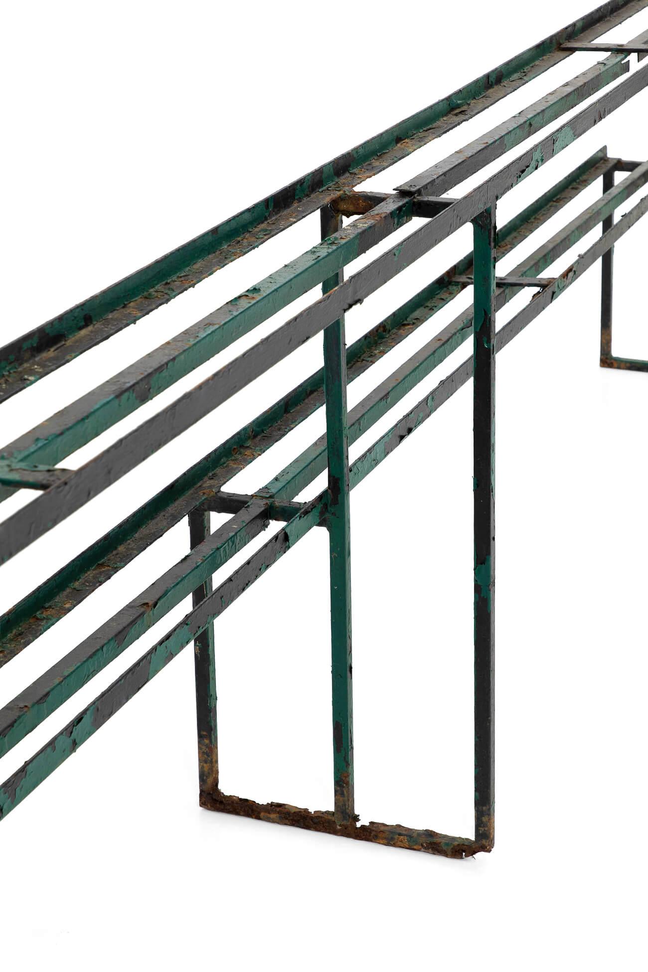 A commanding Parisian two tier florist rack in original condition. In iron strap metal at over twelve feet in length. Decorative and practical in a wonderful flaky green paint. 
France, circa 1910.

Additional information:
H 85 cm (H 33.4