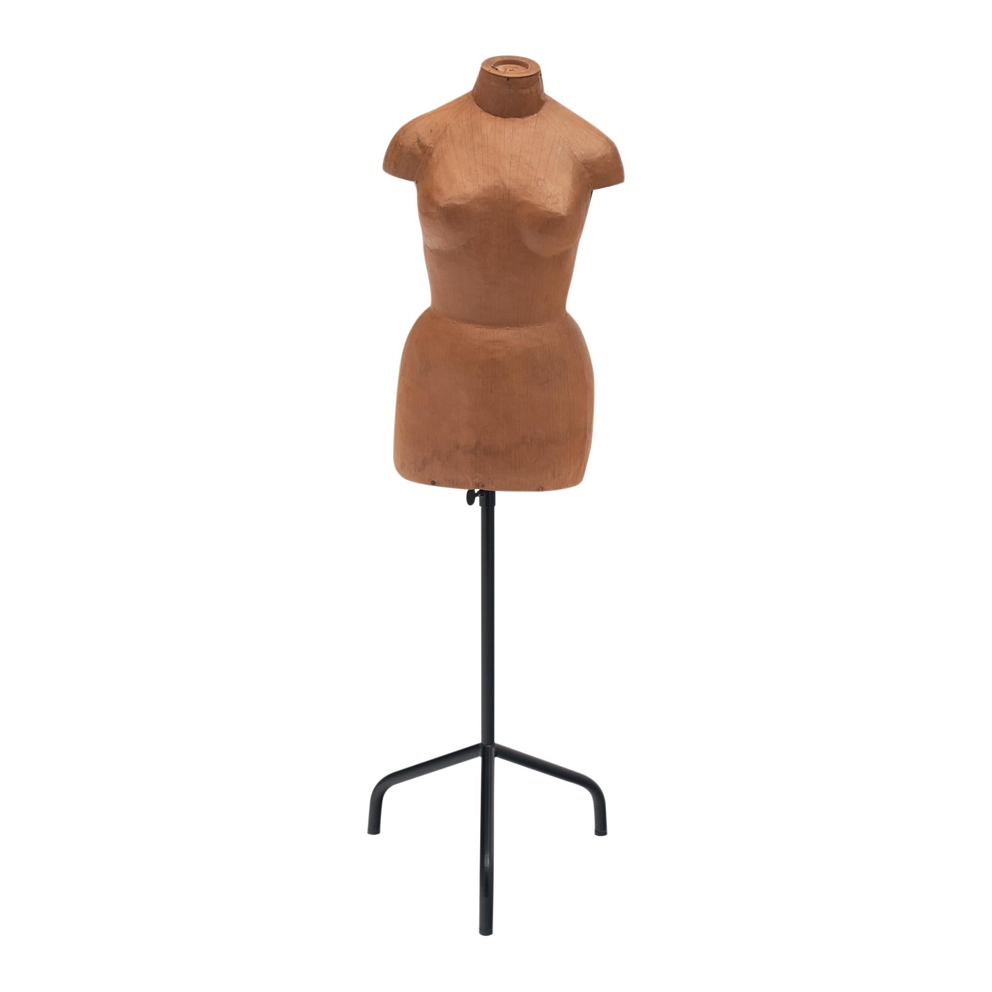 Mannequin from Paris, France made of papier-mâché on a metal tripod stand. The mannequin rests on an adjustable stand that can be lowered down to a height of 43.12”.