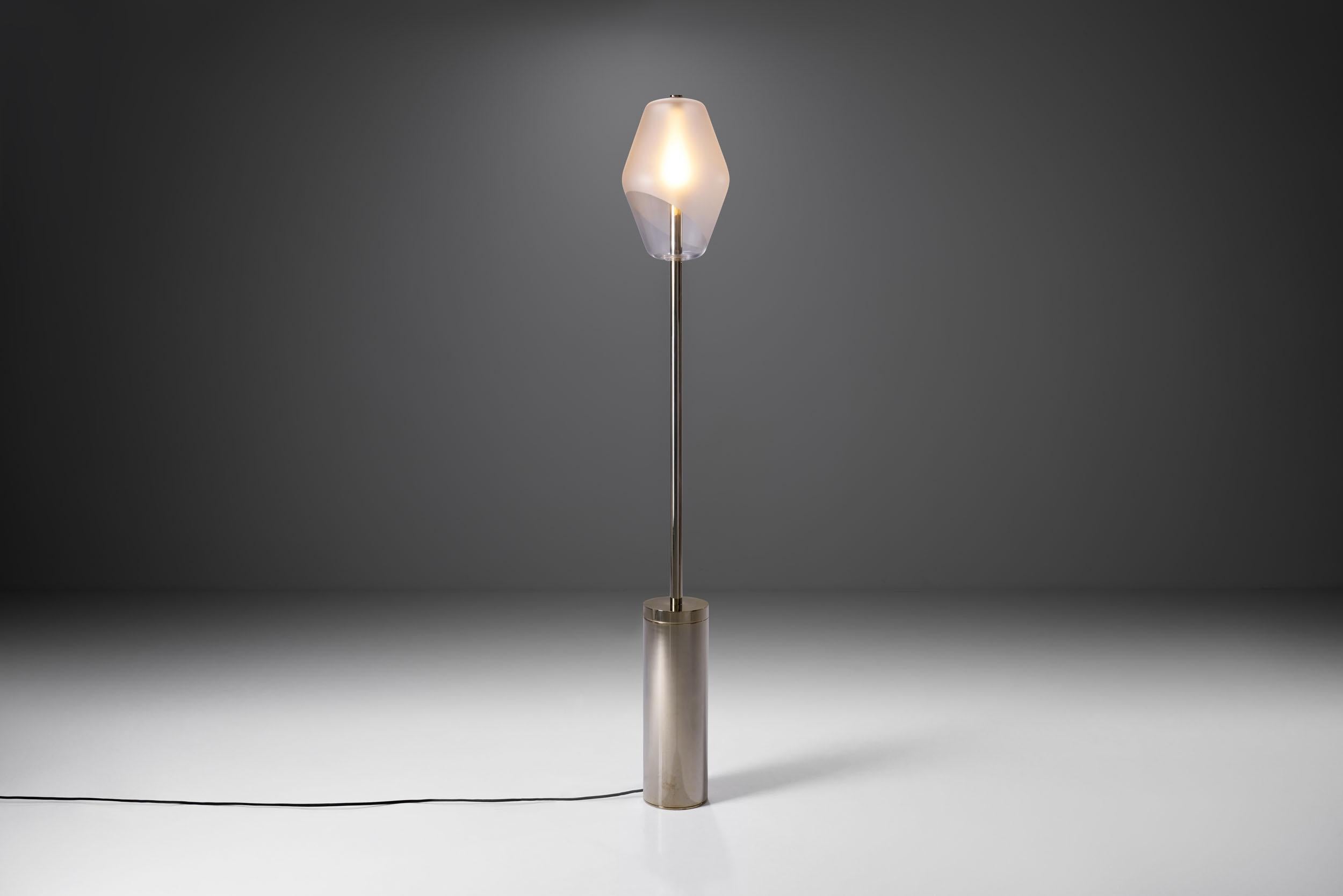 Inspired by the Parisian street lights, Régis Botta designed this floor lamp to create ambient, warm light. This floor lamp is the most striking of the “Parisienne” collection, both in terms of size and design.

Favouring pure, evident lines this