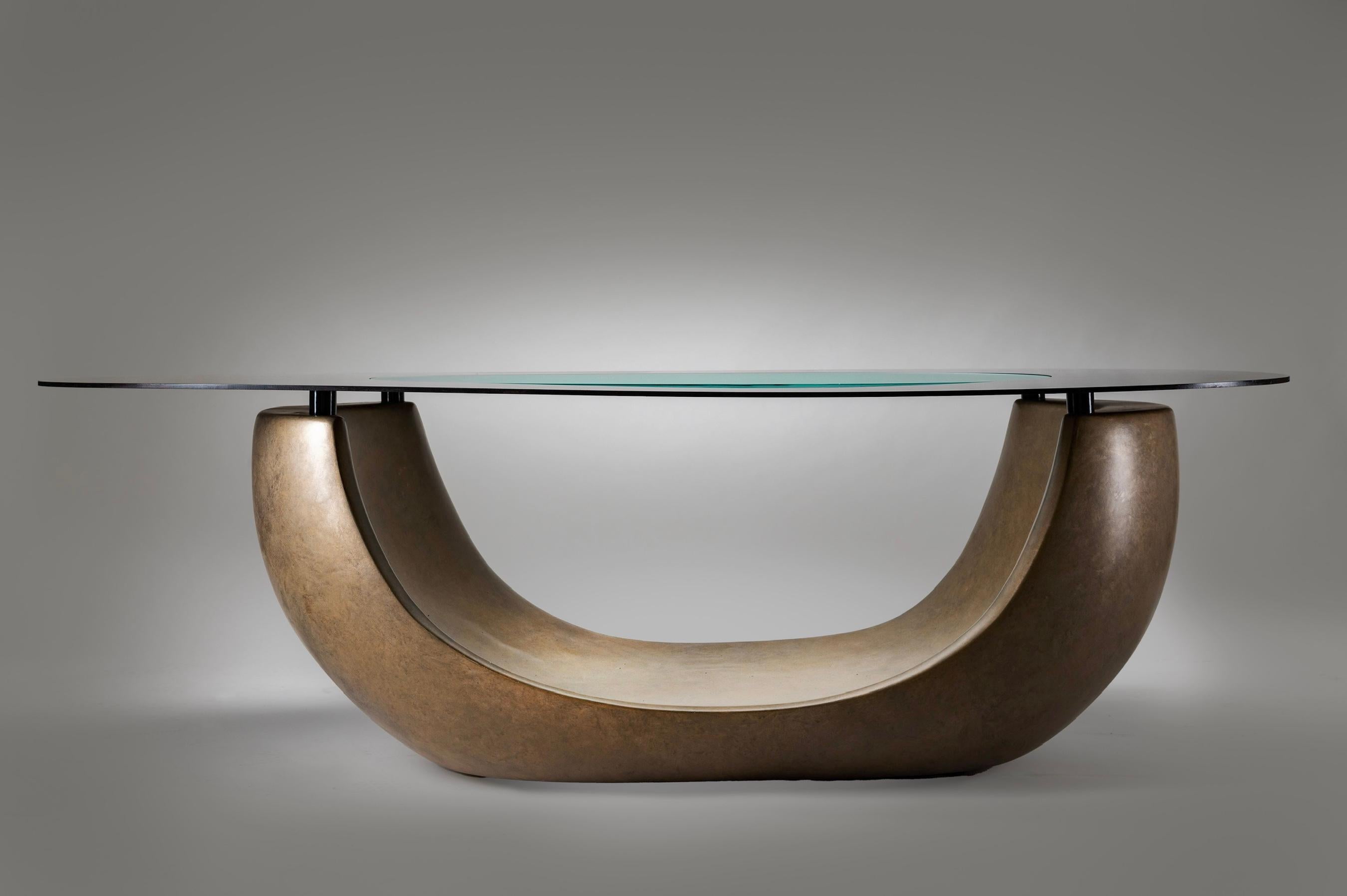 The Breathe Coffee Table, a signature piece in our PARISII line, epitomizes the harmonious fusion of organic form and refined craftsmanship.  Its base  is cast using the cold cast method in a rich aged bronze finish, evoking the fluid shapes found