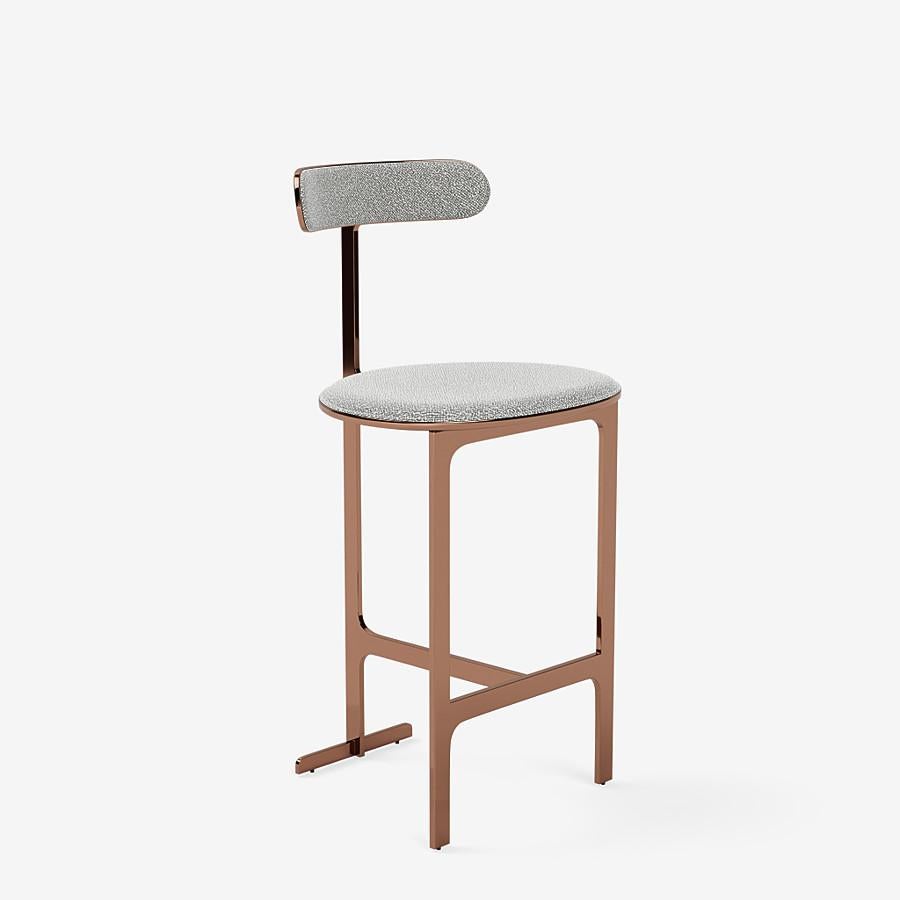 This Park Place counter stool by Yabu Pushelberg in rose copper is upholstered in Dermott Place boucle wool. Dermott Place comes in 4 colorways from Italy with a composition of 42% wool, 33% viscose, 24% cotton and 1% Polyamid, a weight of 1040g/m