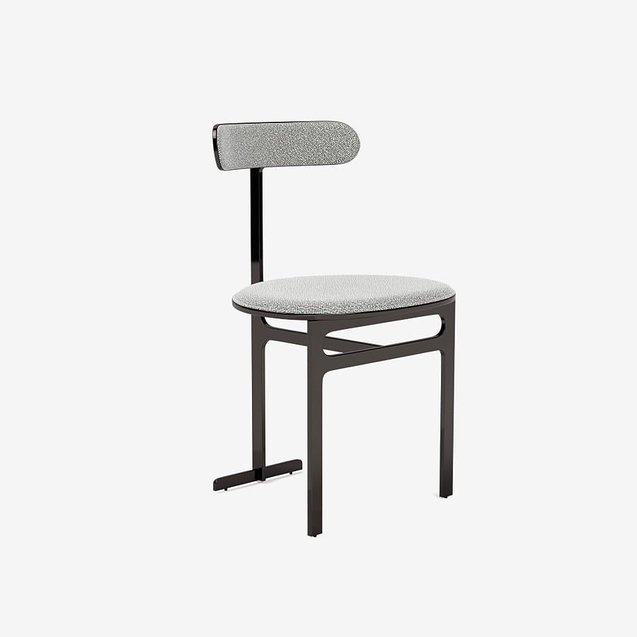 This Park Place dining chair by Yabu Pushelberg in Polished Black Nickel is upholstered in Dermott Place boucle wool. Dermott Place comes in 4 colorways from Italy with a composition of 42% Wool, 33% Viscose, 24% Cotton and 1% Polyamid, a weight of