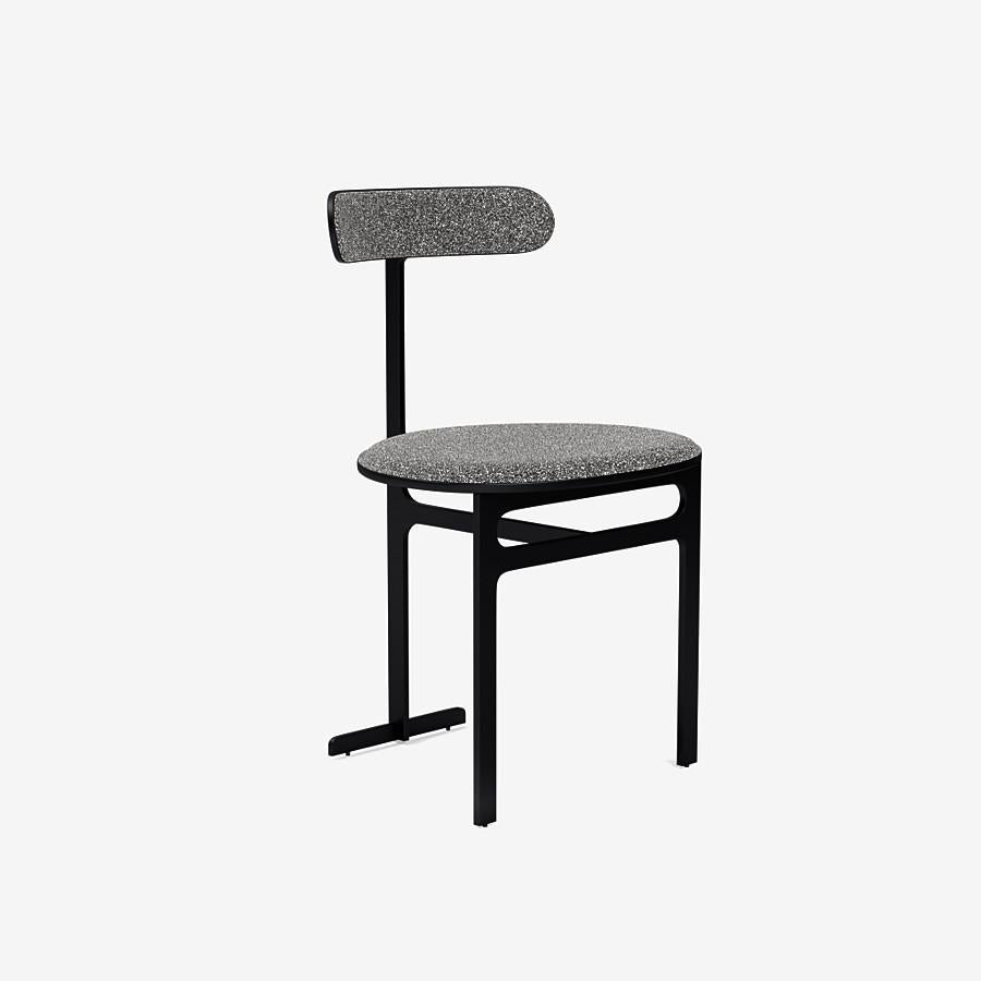 This Park Place dining chair by Yabu Pushelberg in Black Soft Touch is upholstered in Place de l'Étoile, muliti-toned bouclé. Place de l'Étoile comes in 5 colorways from Belgium with a composition of 65% Cotton, 20% Polyacrylic, 15% Polyester, a