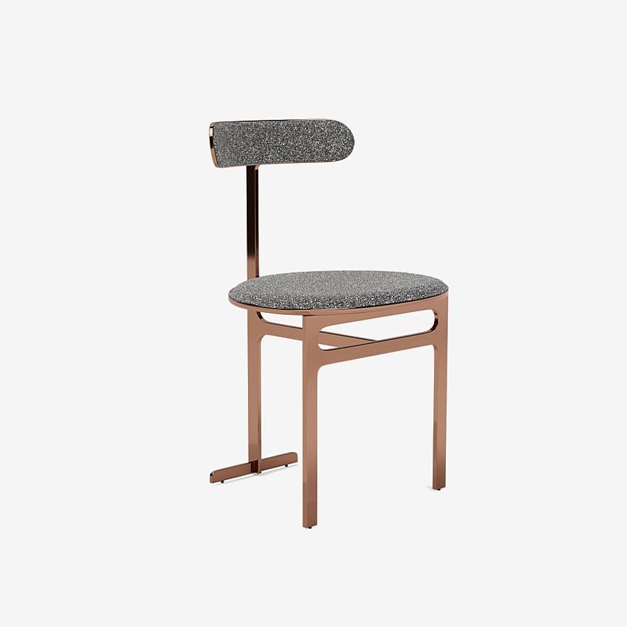 This Park Place dining chair by Yabu Pushelberg in Rose Copper is upholstered in Place de l'Étoile, muliti-toned bouclé. Place de l'Étoile comes in 5 colorways from Belgium with a composition of 65% cotton, 20% polyacrylic, 15% polyester, a weight