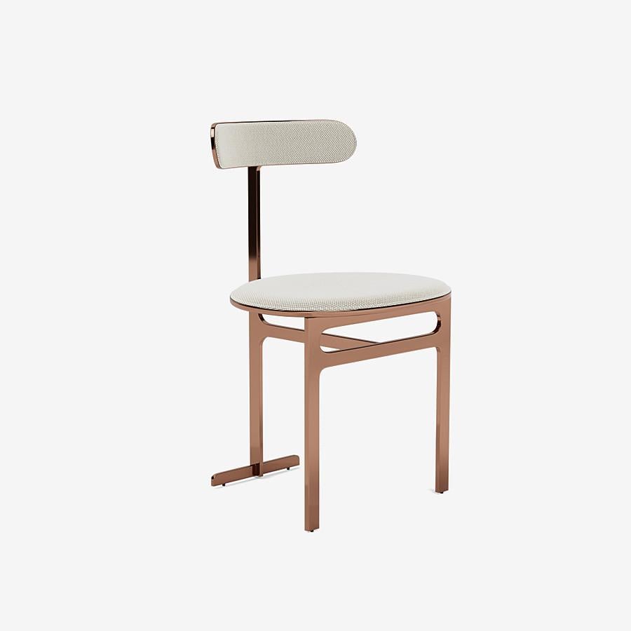 This Park Place dining chair by Yabu Pushelberg in rose copper is upholstered in Geneva Avenue textured wool. Geneva Avenue comes in 5 colorways from Germany with a composition of 96% Virgin Wool and 4% Polyamide, a weight of 1010g/m and a