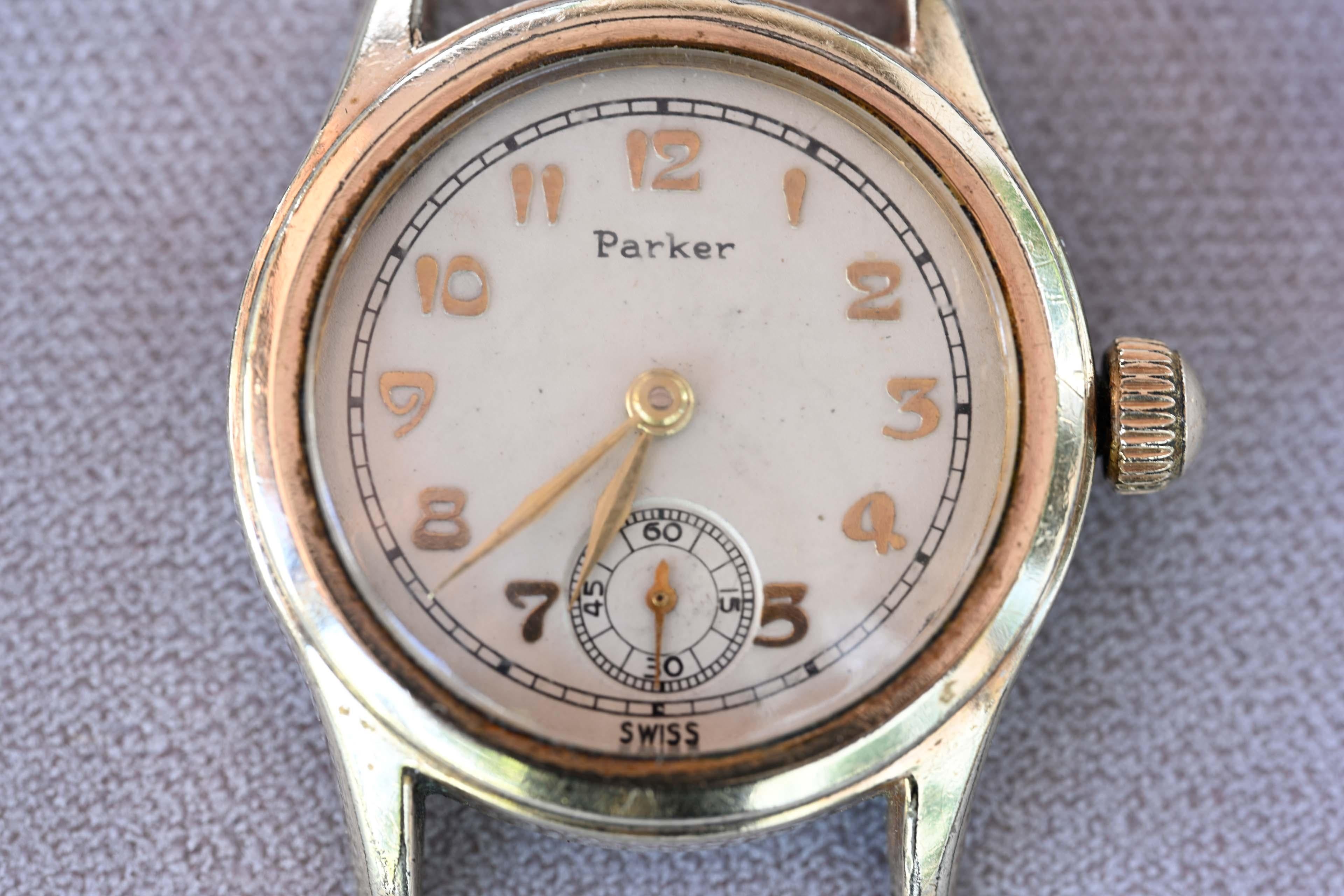 Parker military WW2 era watch with 7 jewels and mechanical movement. Swiss-made, #10A405. The case size is 29mm without the crown. In good working order, with dial and Roman numerals. Gold-tone harms, wear is consistent with age, no strap and no