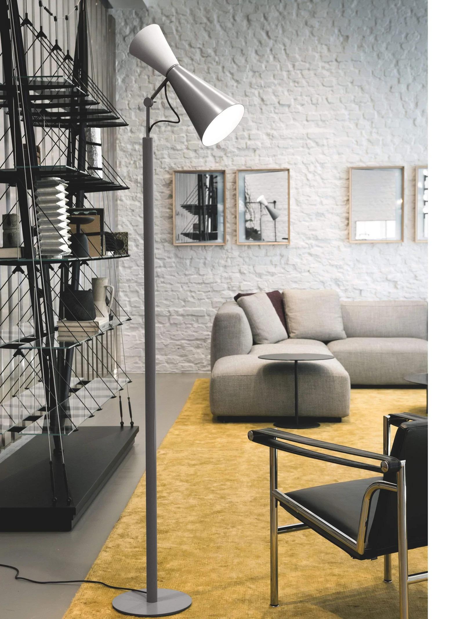 Designed for his masterful Chandigarh Parliament building, Le Corbusier‚ Parliament floor lamp is both elegant and functional. It is adjustable in height and features two cone shaped diffusers that swivel for direct or indirect light. This lamp