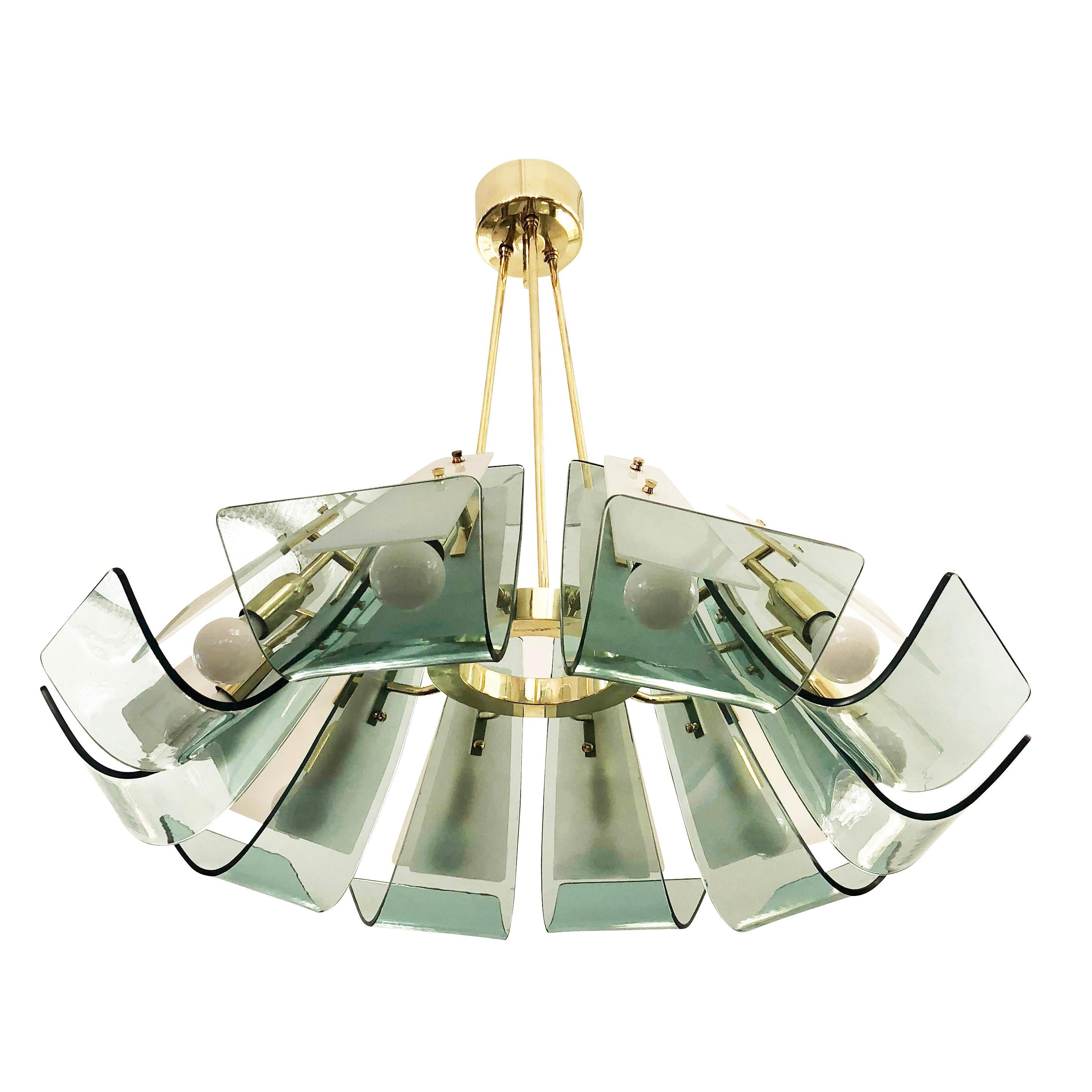 Italian midcentury chandelier by Paroldo featuring ten curved laguna green glasses on a brass frame. Each arm also has a frosted glass cover to help conceal the light sources. Overall height can be adjusted on request.

Condition: Excellent