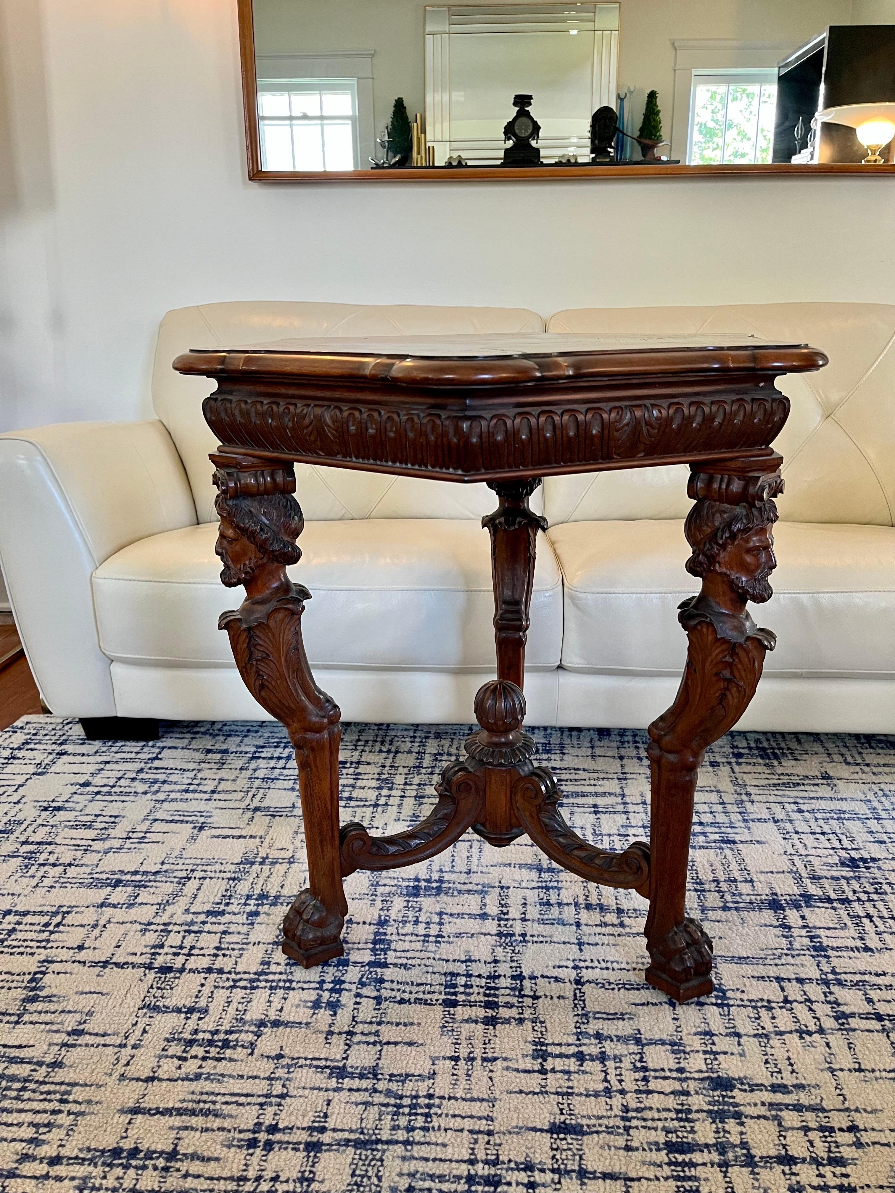 Beautifully carved wooden center or entry table with intricate Parquet top  surface. The stretchers with acanthus detail topped off with wonderful finial. Legs feature male busts atop acanthus leaves and claw feet. 
Curbside to NYC/Philly $400