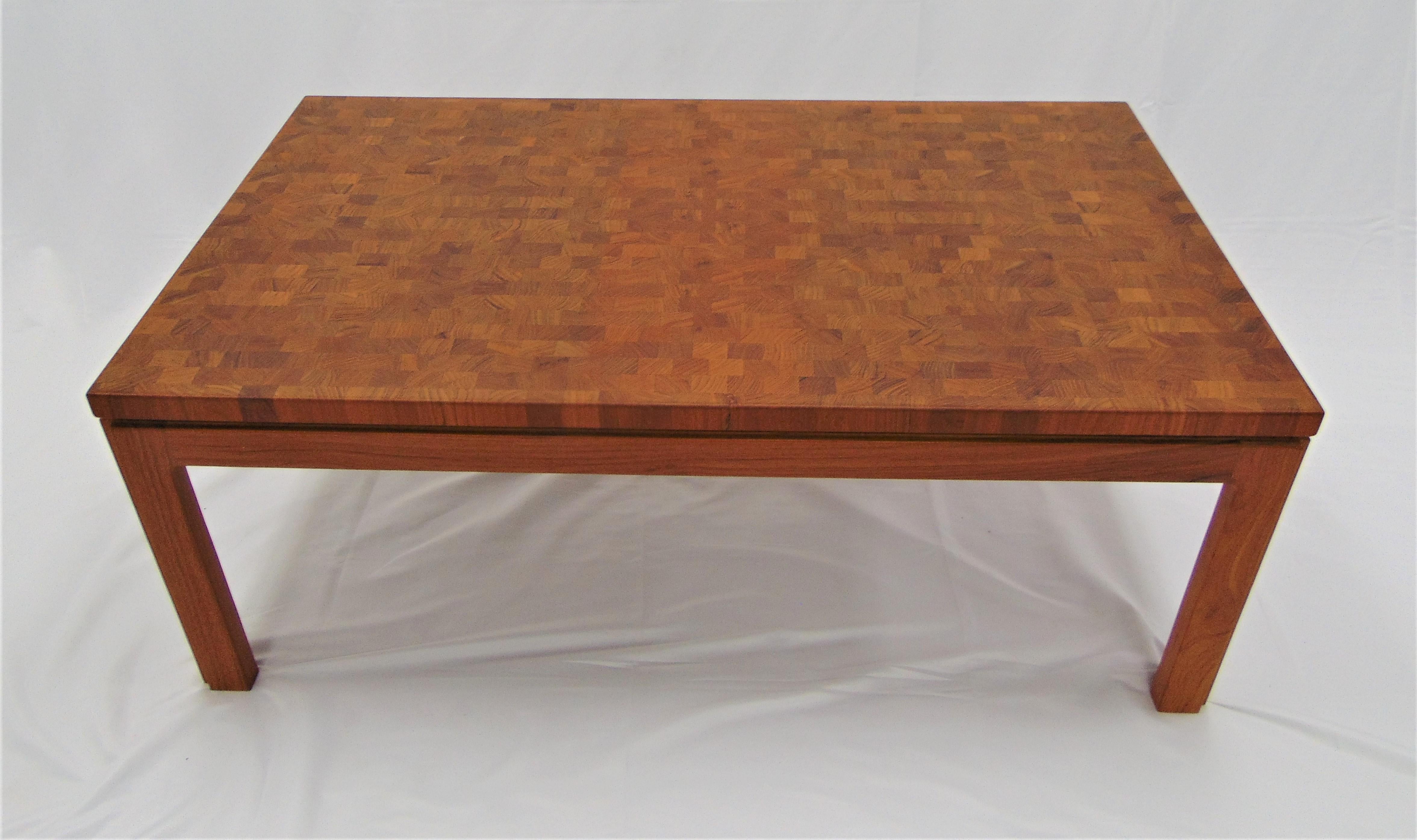This is a beautiful and rare midcentury coffee table by Tarm Stole of Denmark. It is made of teak wood in a parquetry pattern. The overall condition is great but there is a discoloration in the middle of the table where it is appears more