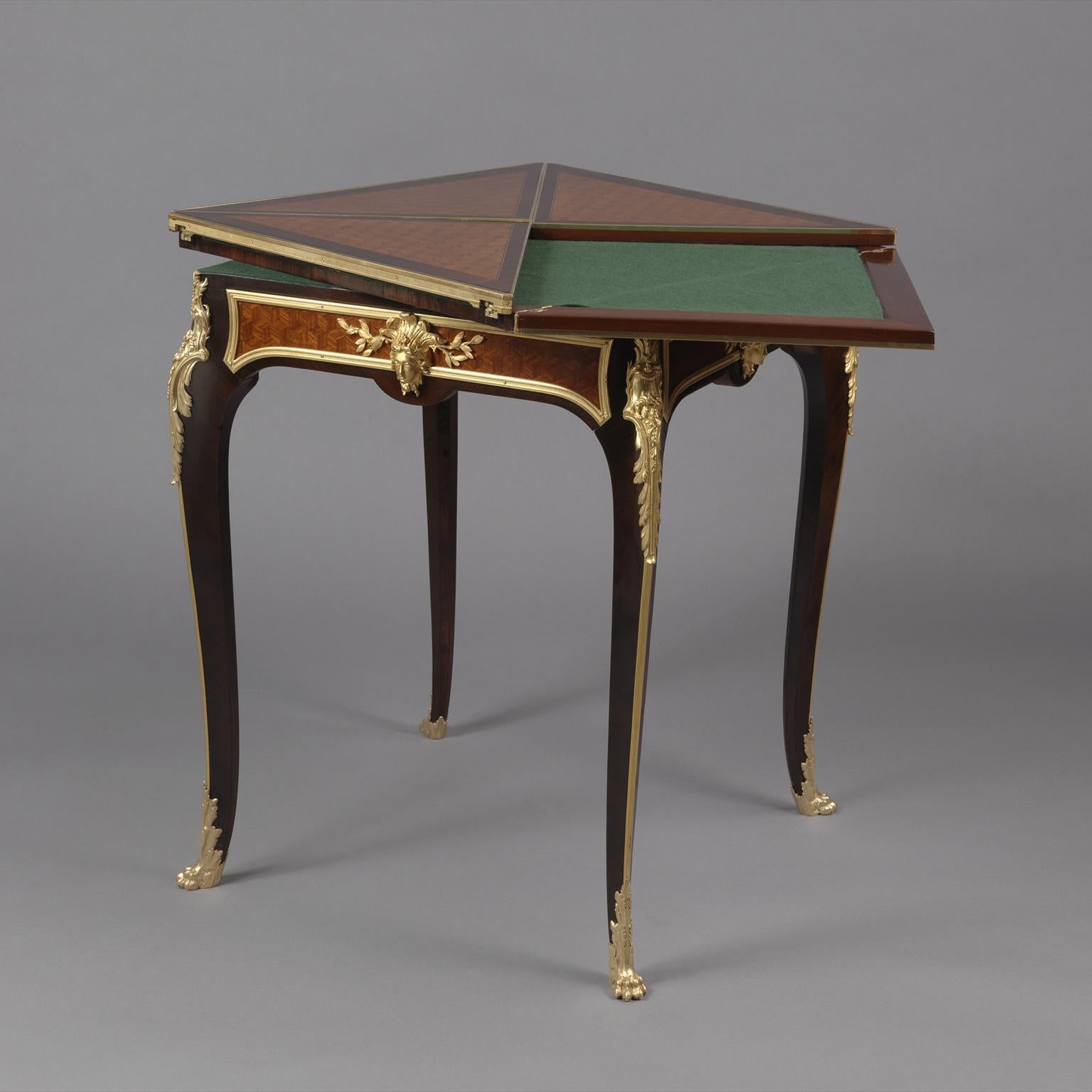 A gilt-bronze mounted parquetry envelope card table by François Linke.
 
Signed to the gilt-bronze 'Linke'. 

This fine card table has a swivel top, with four 'envelope' panels, opening to a green baize playing surface, below is a frieze drawer