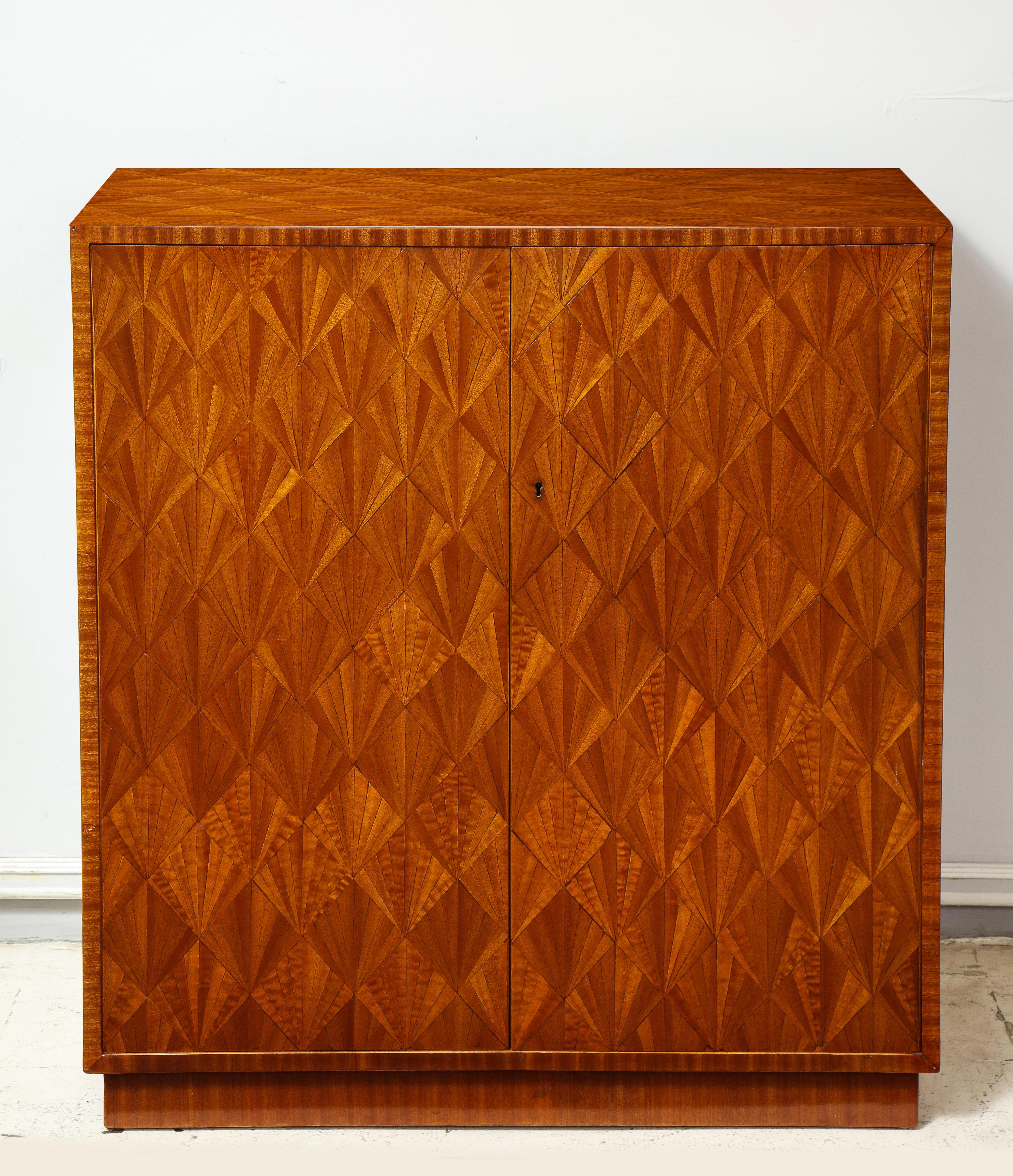 Exquisite Parquetry sycamore cabinet in the Jean-Michel Frank manner, parquetry work emulates straw marquetry found in French Art Deco design.

Measures: H 38.5 in. x W 35.5 in. x D 15 in.