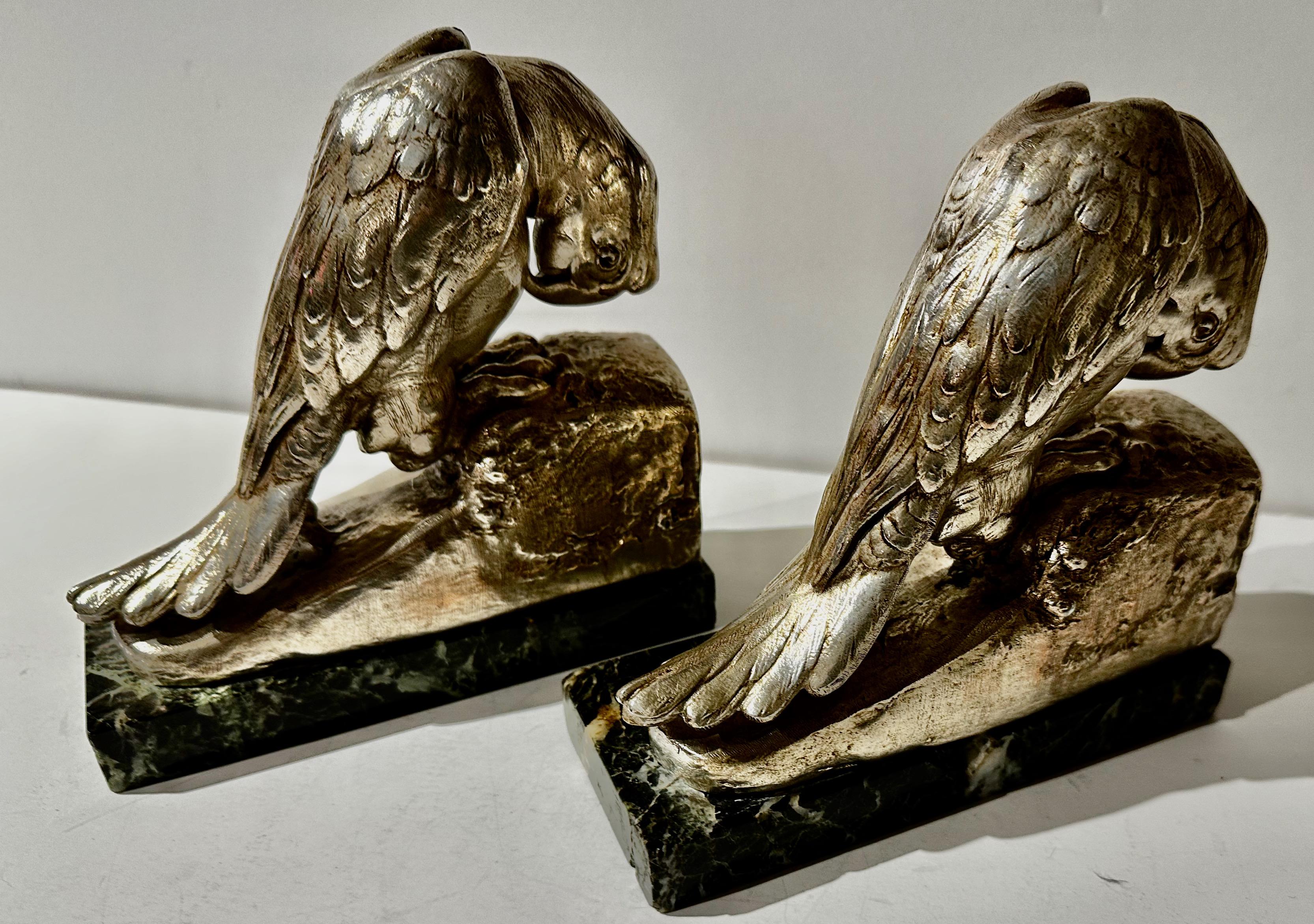 Parrot Art Deco Bookends by Georges Vandevoorde Silver Finish. Signed by the artist on the side and with the BRIG founder’s seal in front. Unusual restored silver patina on metal mounted on a variegated marble base, circa 1925.

There is a picture