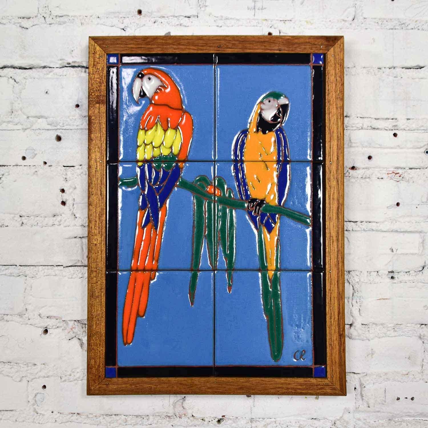 Marvelous vintage Catalina style majolica parrot ceramic tile plaque by Christopher Reutinger for Catalina Picture Tile (formerly named Palisade Tile which is what this piece is marked). Incised and embedded in a rich mahogany frame. Beautiful