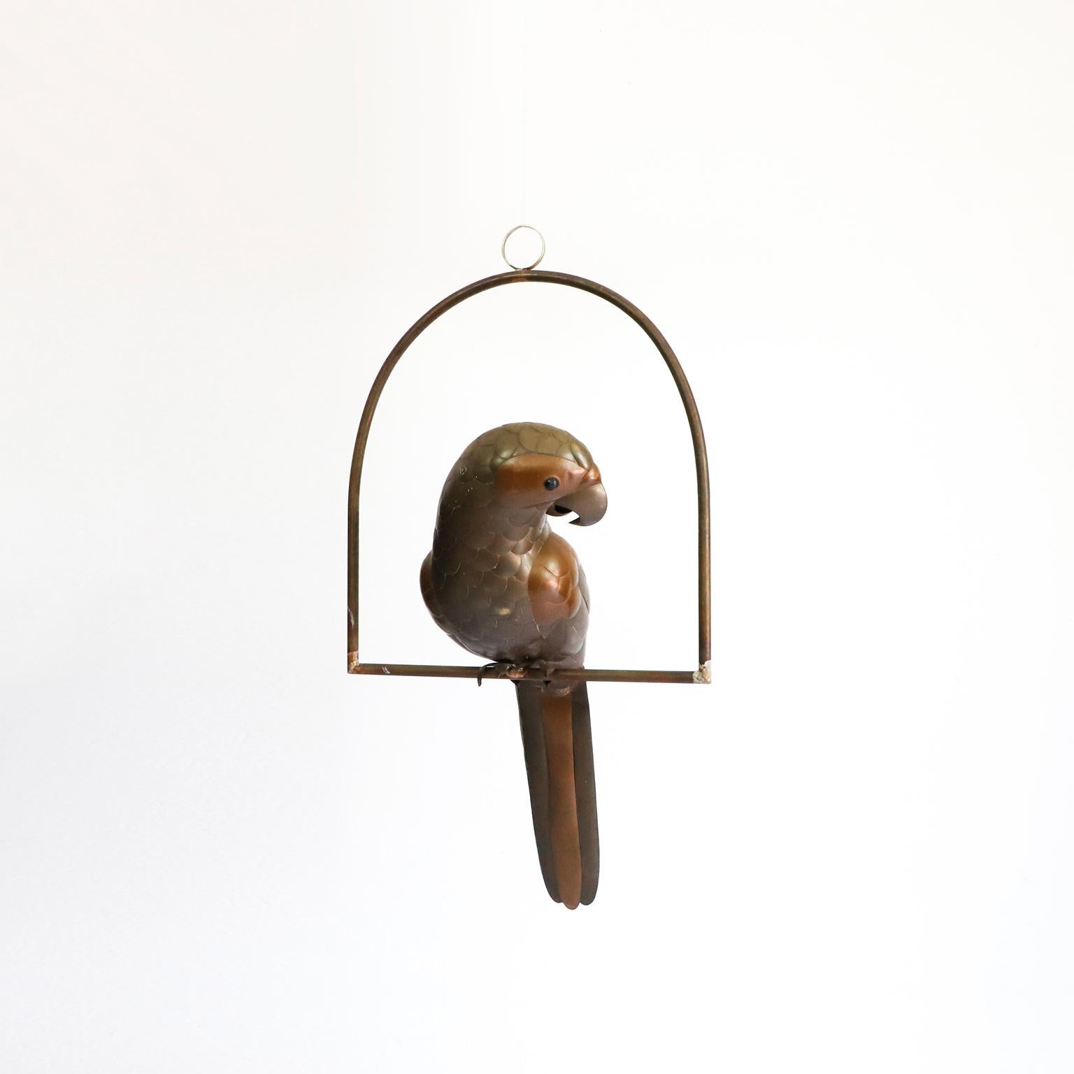 Copper, brass and aluminium Parrot on a hoop hanging stand by Sergio Bustamante, circa 1960.

Sergio Bustamante is a Mexican Artist and sculptor. He began with paintings and papier mache figures, inaugurating the first exhibit of his works at the
