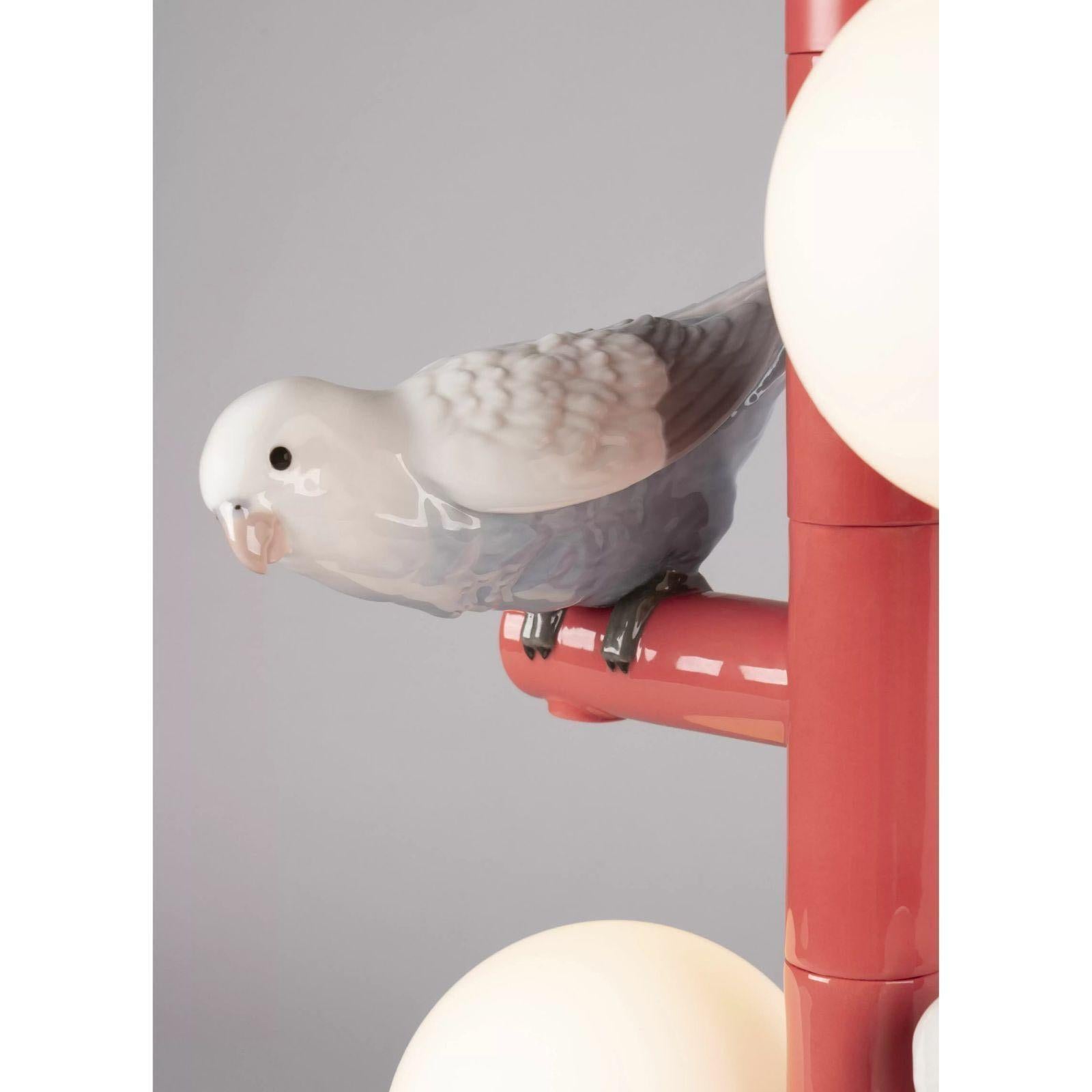A table lamp from the Parrot Party collection, a fun-loving lighting concept based on the contrast between the pure geometric design of functional objects and the highly realistic depiction of the cute birds that decorate them.

Made in porcelain