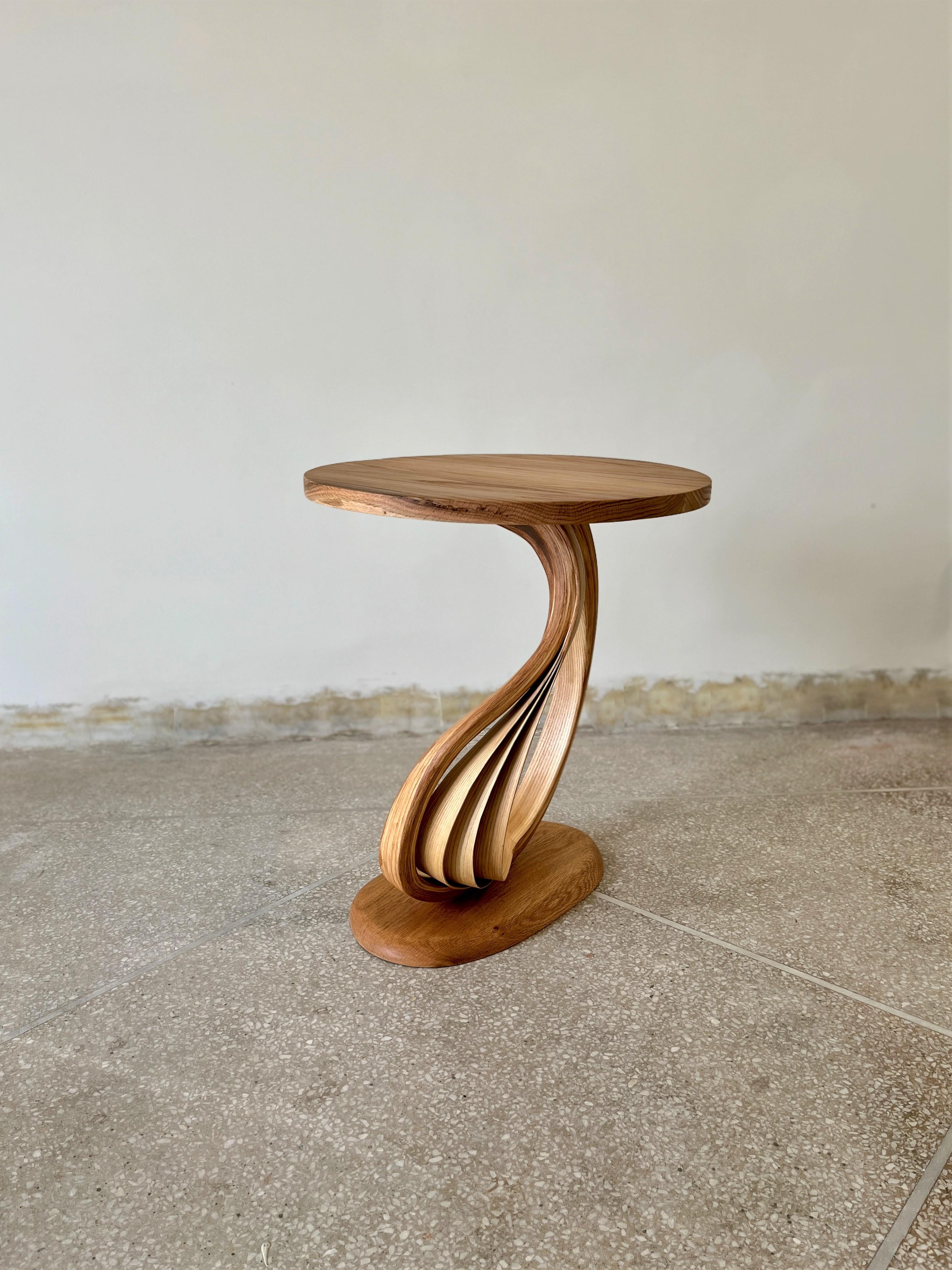 Pars Side Tabel is a bent wood design made by Raka Studio.

This piece's main element is bentwood's organic motion between the top and the base. The proportions of the top and the base are made to enhance the centre design of the piece. The piece