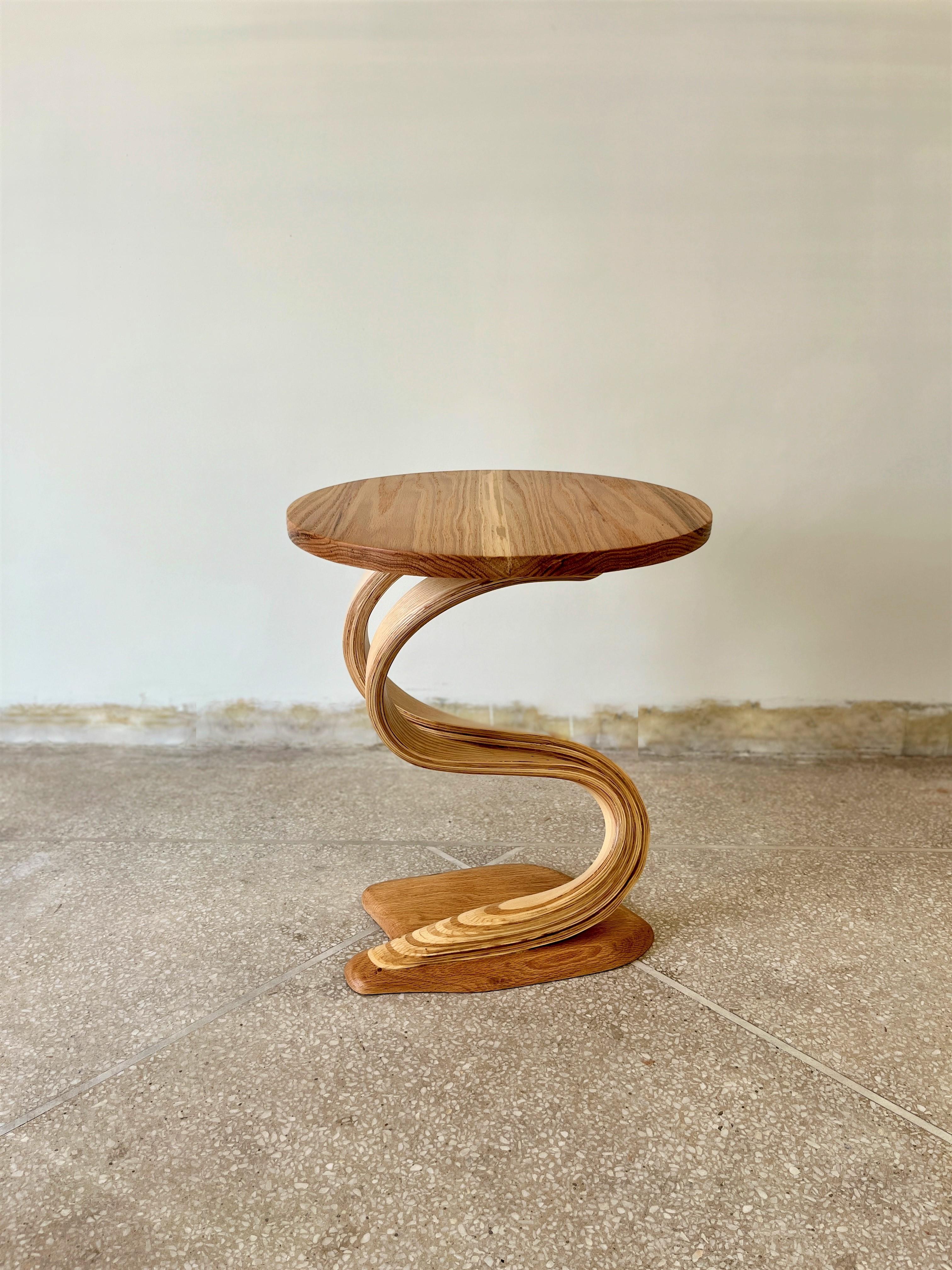 Pars side tabel III is a bent wood design made by Raka Studio.

This piece's main element is bentwood's organic motion between the top and the base. The proportions of the top and the base are made to enhance the centre design of the piece. The