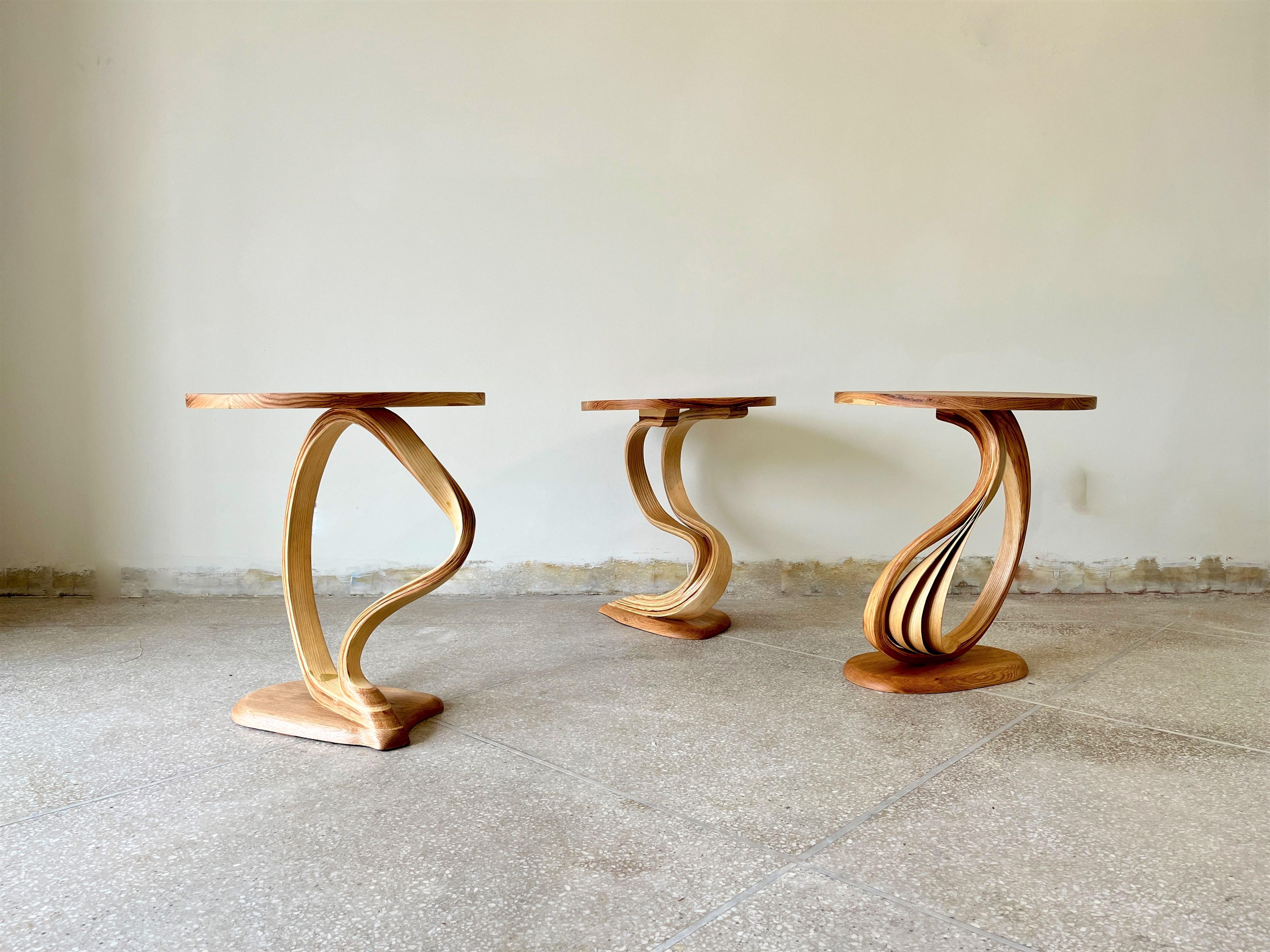 Pars side tables are a bent wood design made by Raka Studio.

This piece's main element is bentwood's organic motion between the top and the base. The proportions of the top and the base are made to enhance the centre design of each piece. The