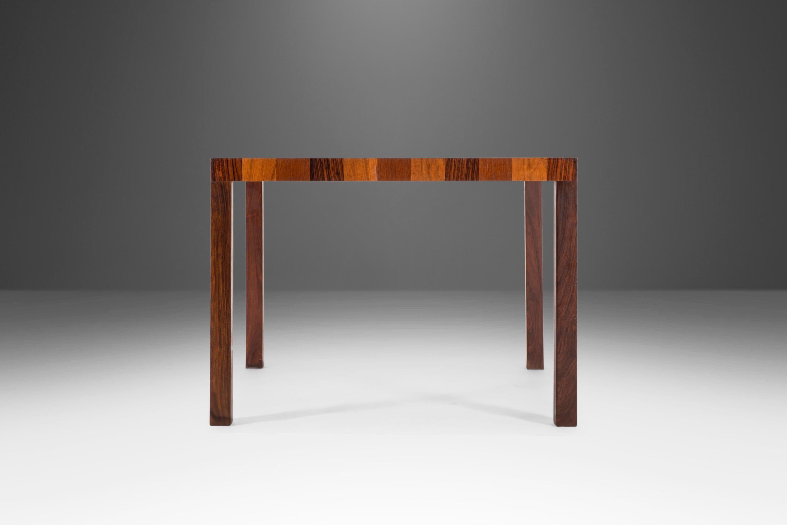 Simple and yet absolutely stunning; a parsons table constructed from walnut and teak. Attributed to Milo Baughman for Directional this extraordinary dining table features a striped veneer top of gleaming teak, walnut and rosewood with smooth clean