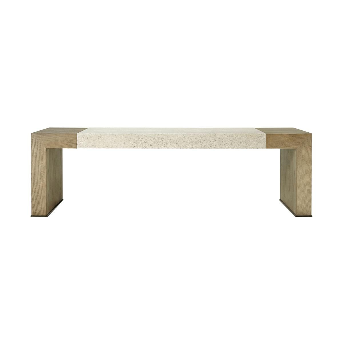 A  modern parsons style cocktail table made of figured cathedral ash in our light dune finish with our exclusive Mineral finish at the top and metal detail at the base of the legs in a bronze finish.
Dimensions: 55