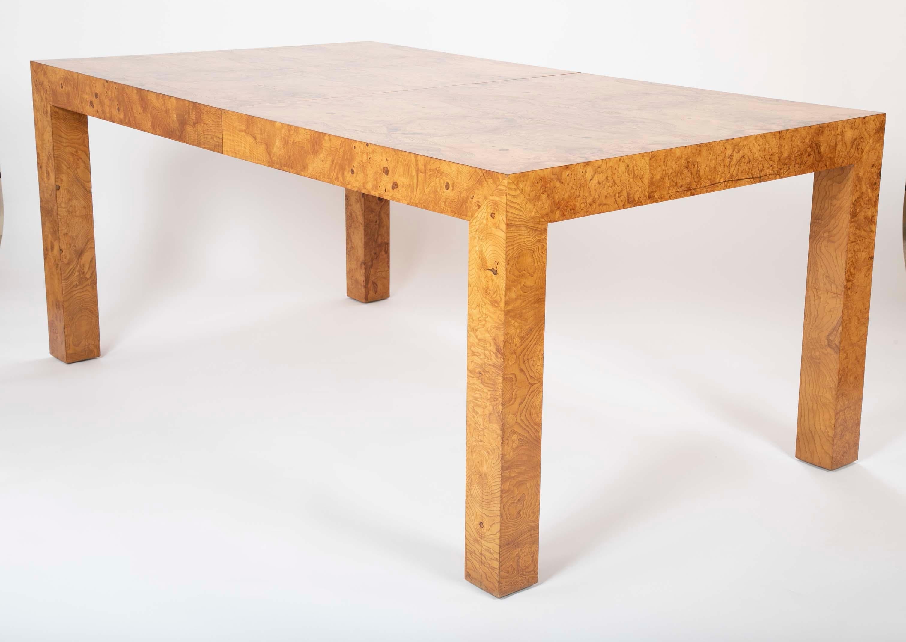 A Parsons style olivewood dining table design attributed to Milo Baughman. The table has 22