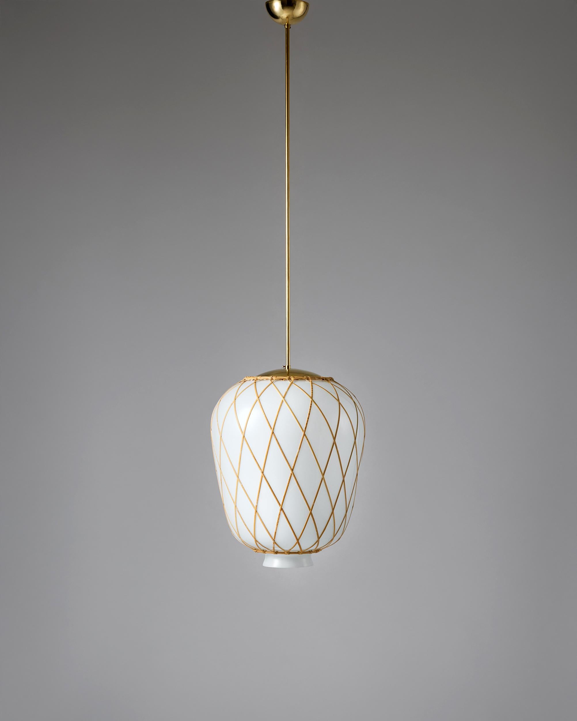 Ceiling lamp designed by Harald Notini for Böhlmarks, Sweden, 1930s.

Mouth-blown glass, cane and brass.
This ceiling lamp by Harald Notini was designed in the 1930s and features a mouth-blown glass shade that emits a soft, warm light, creating an