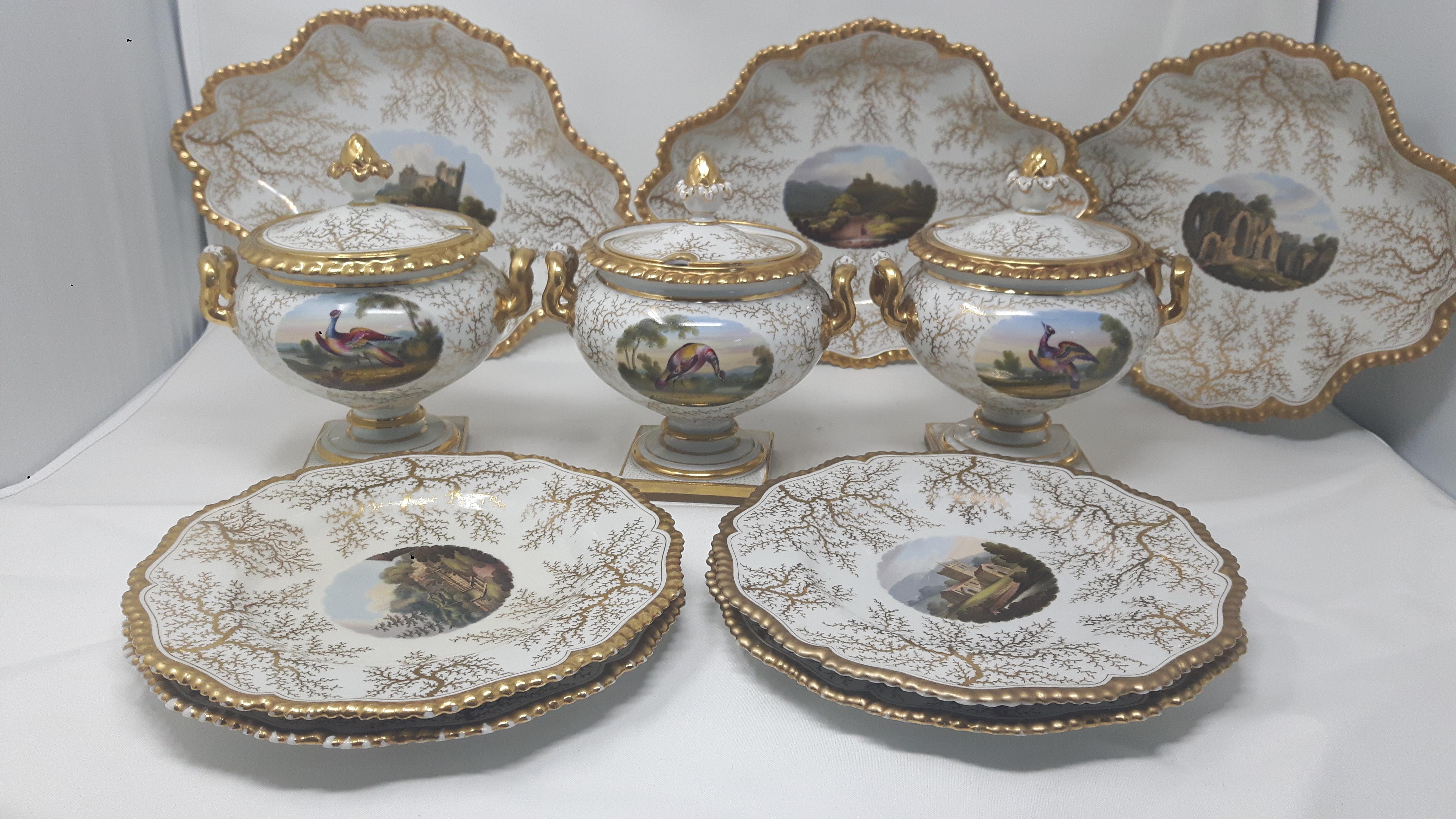A part dessert service by Worcester, hand-painted on a white background with gilded coral designs surrounding hand-painted cartouches of famous British castles and bird scenes.
English, Coalport Porcelain, circa 1890.