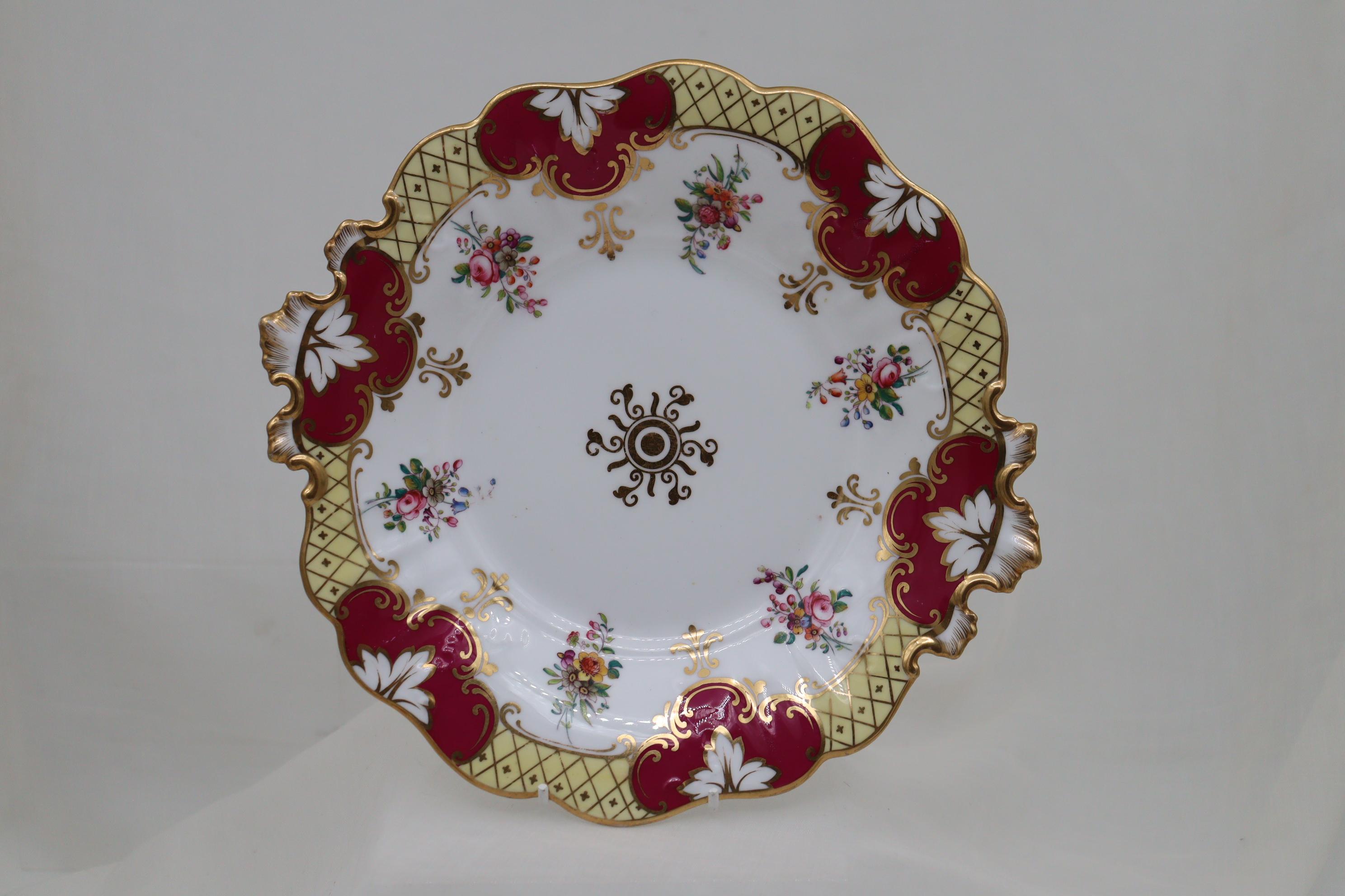 This very attractive twenty-two piece porcelain part tea set by John Ridgway consists of two bread and butter or cake plates, six cups saucers and plates,a slop bowl and a creamer. The set is in Ridgway's Savoy shape and is decorated with an edge