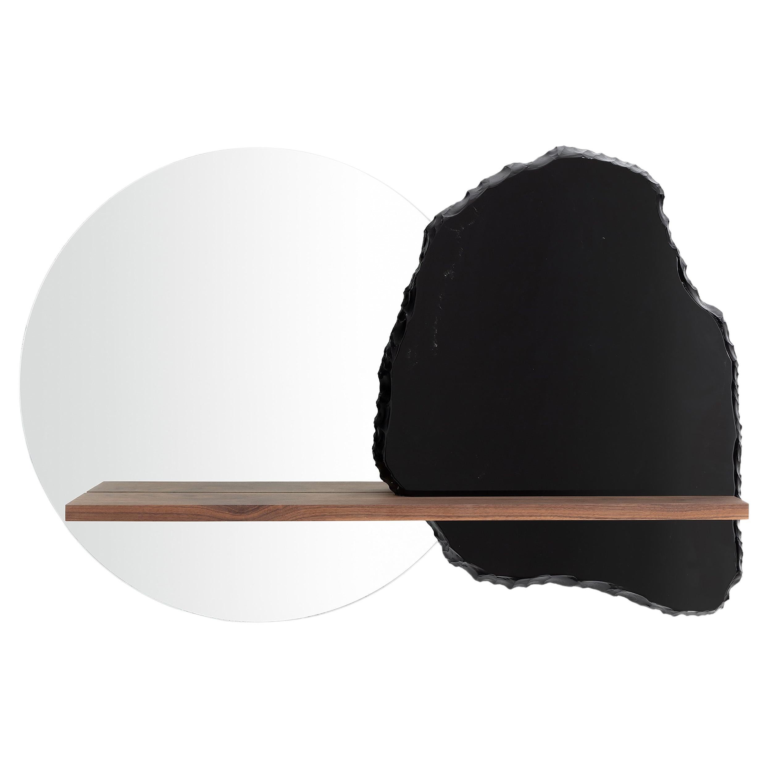 Partial Eclipse by Sten Studio

51.2” W x 6.6” D x 29.5” H
Obsidian, mirror and wood

The central metaphor of this piece is achieved thanks to a material contrast in which the „coldness“ of the obsidian and the mirror creates a dialogue with the
