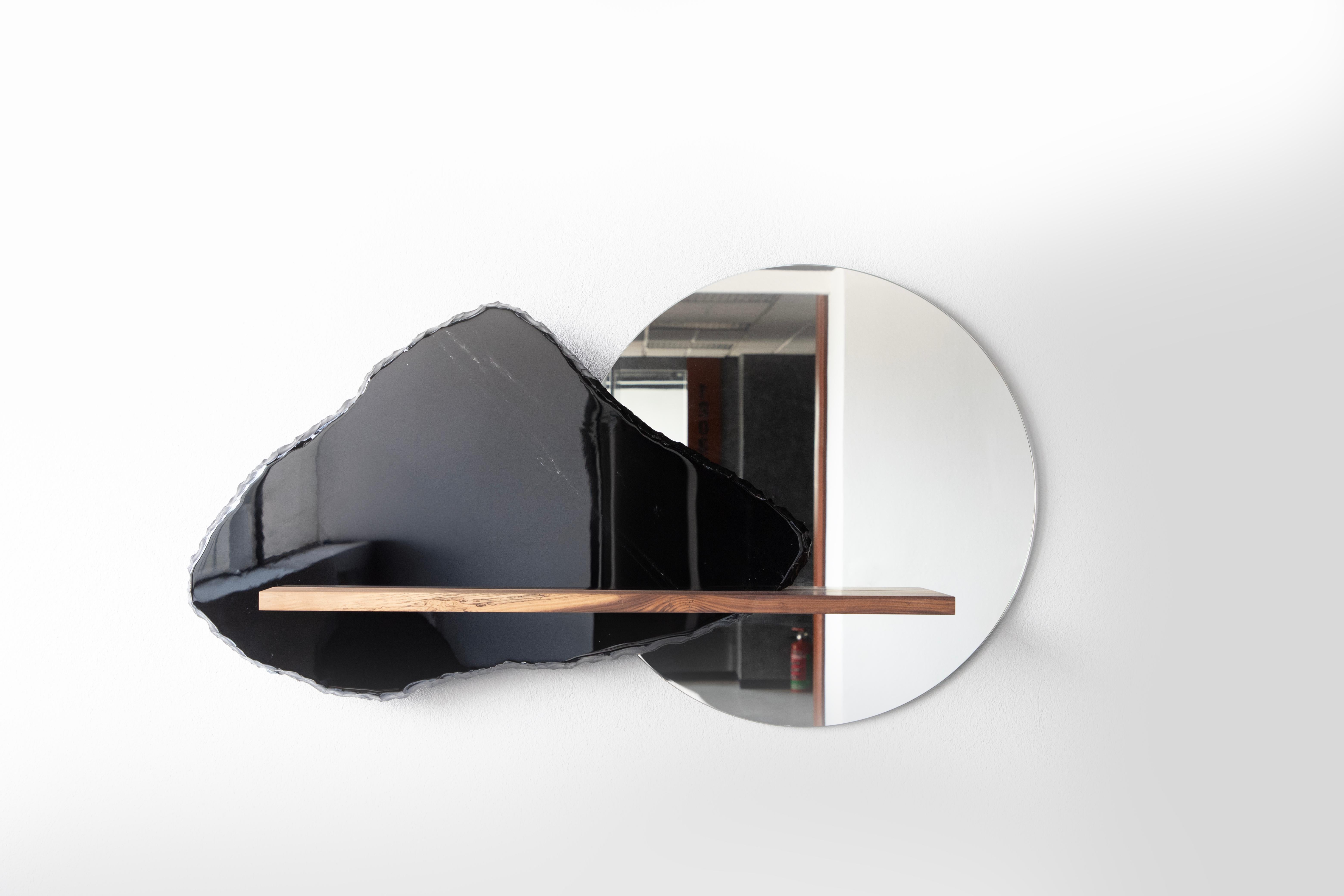 Obsidian, mirror and walnut
Collaboration with FOAM studio
Handcrafted

The central metaphor of this piece is achieved thanks to a material contrast in which the perceived coldness of obsidian and the mirror creates a dialogue with the warmth of the