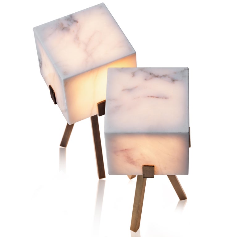 In Particle table lamp, on.entropy mines the modern design potential of this classical material, by transforming the austerity of raw marble into a warm and bright lamp. 

Cubicle consists of a seamless volume of marble and a tripod bronze base.