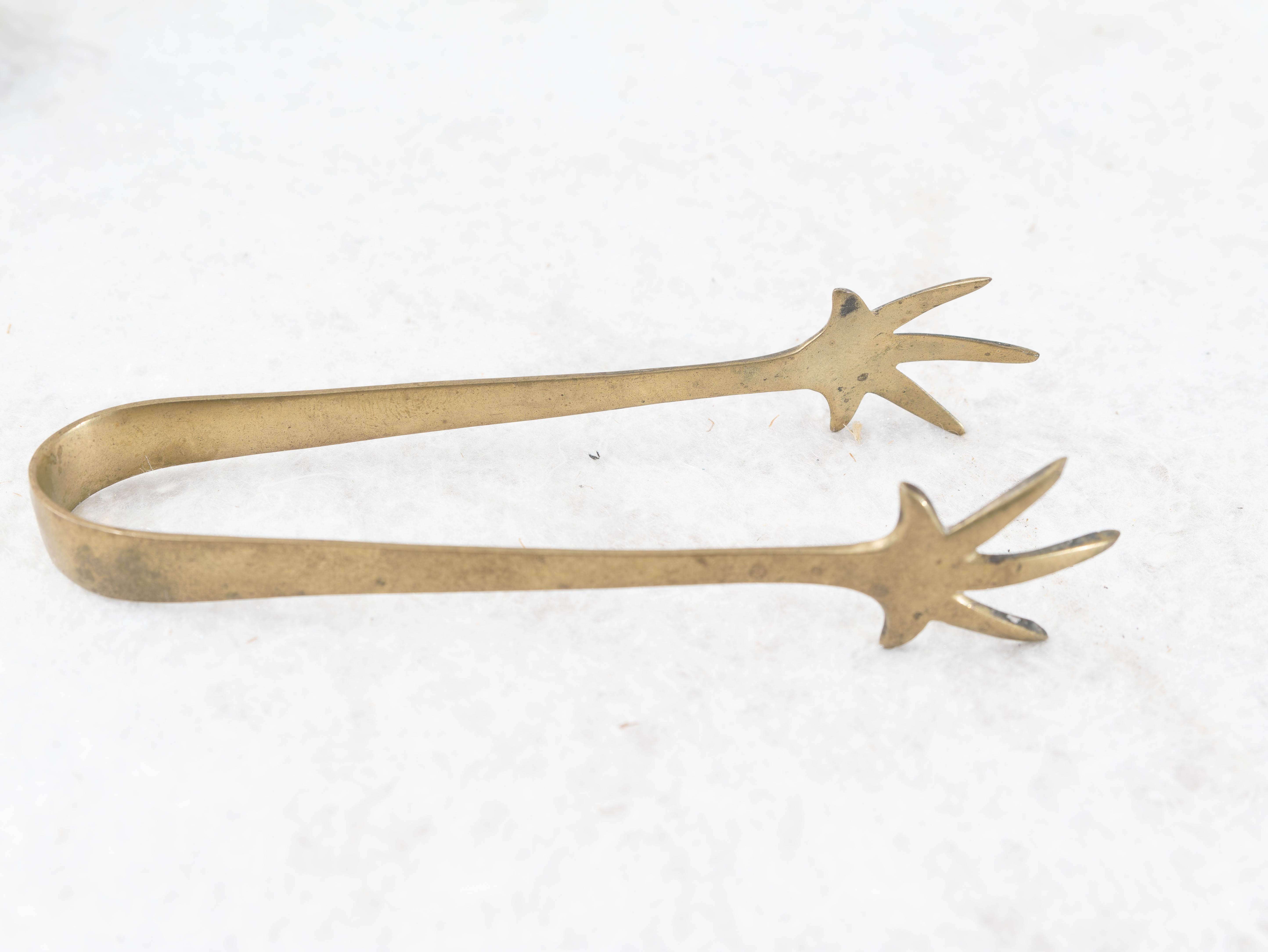 Peculiar ice box with pliers made of BRASS, Made in Italy, 1930s. 
Very rare 1930s brass ice box finely cared for and completely hand engraved with floral designs. At the bottom is a small perforated grating that acts as a water filter. It is