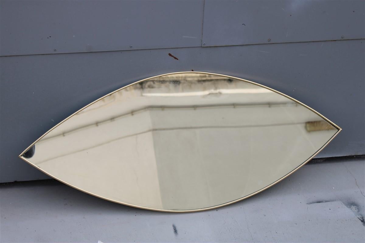 Particular midcentury Italian Eye shaped mirror in shaped brass 1950s.