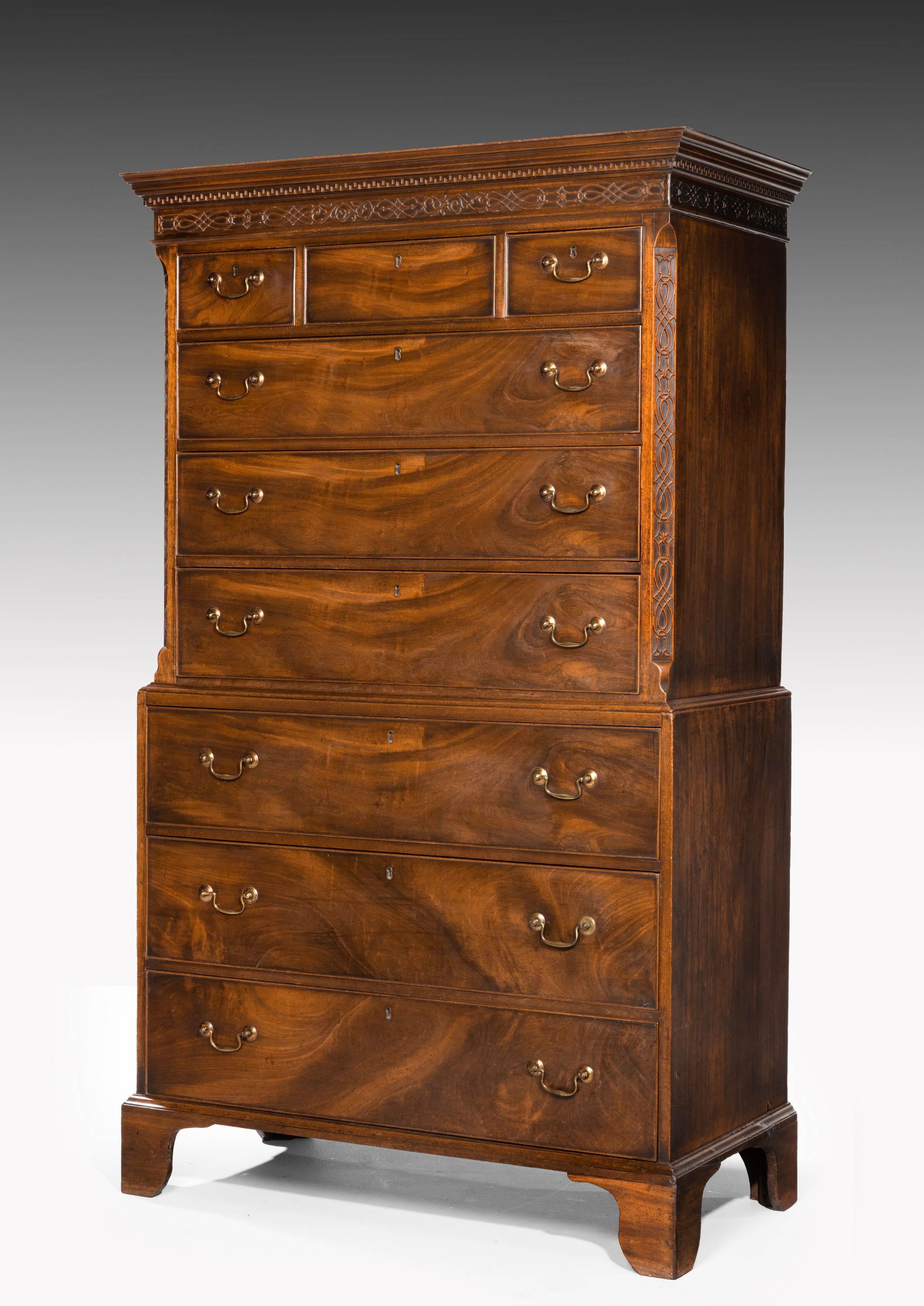 A particularly fine Chippendale period mahogany chest-on-chest. The top section with canted corners and the border with the finest quality blind fret carving over a Grecian deep patination. Find period original handles retaining the gilding. The