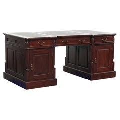 Partner desk in English style with dark wood and a green leather top