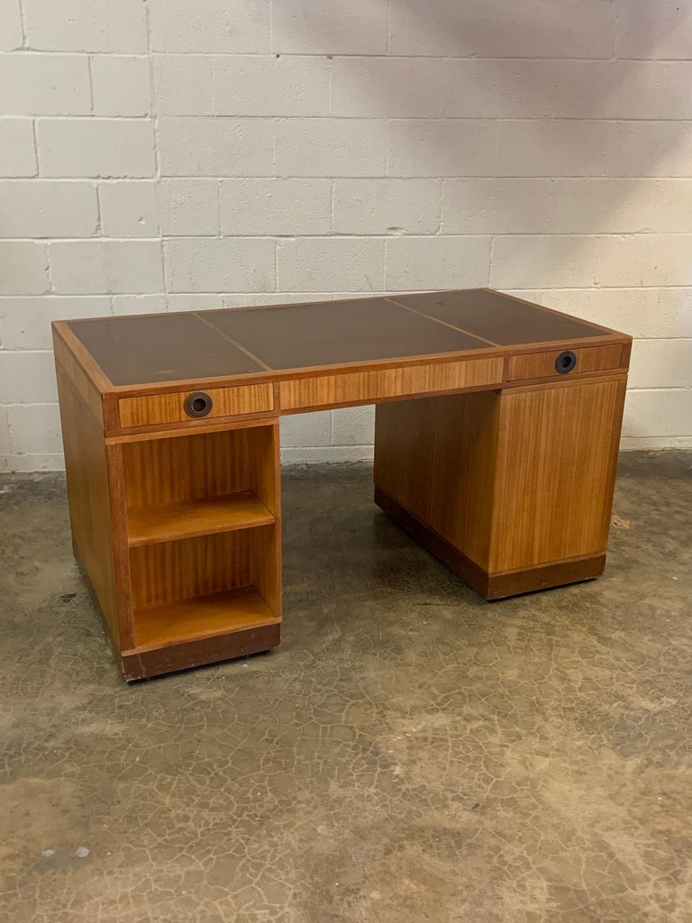 A mahogany partners desk with original leather top and base and brass hardware. Designed by Edward Wormley for Dunbar.