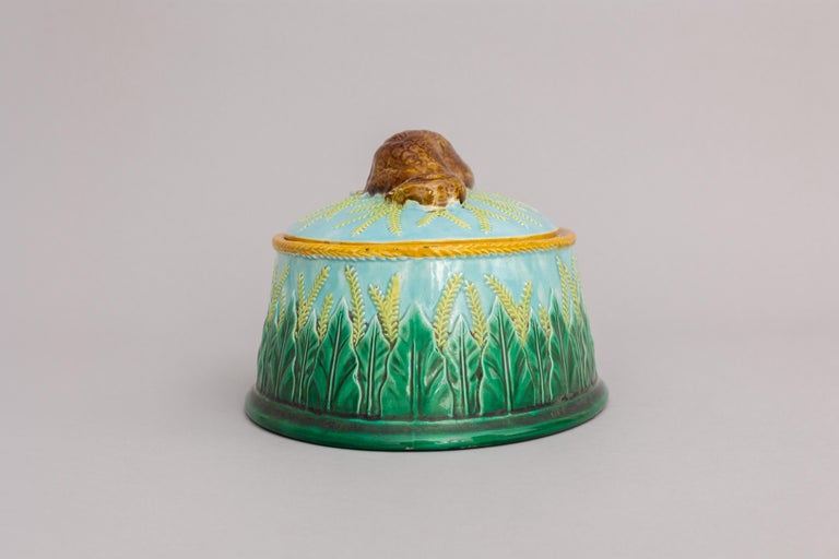 A majolica game pie dish designed by George Jones circa 1867-1869 in the ‘Partridge’ shape. The game pie dish is decorated with a lovely turquoise majolica glaze and a stylized wheat pattern on the body. Atop the lid is a realistic partridge,