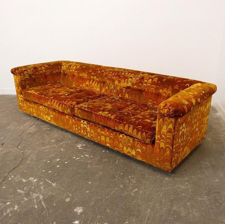 A Classic Dunbar sofa by Edward Wormley that has been ensconced in plastic since leaving the showroom. Thereby preserving the spectacular and timeless fabric of Jack Lenor Larson in colors of rust, browns, and oranges.

Edward Wormley worked in that