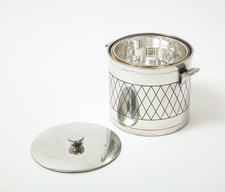 Mid Century Modern cast aluminum ice pail with a mercury glass inner liner and lid. An engraved diamond pattern circling the perimeter.